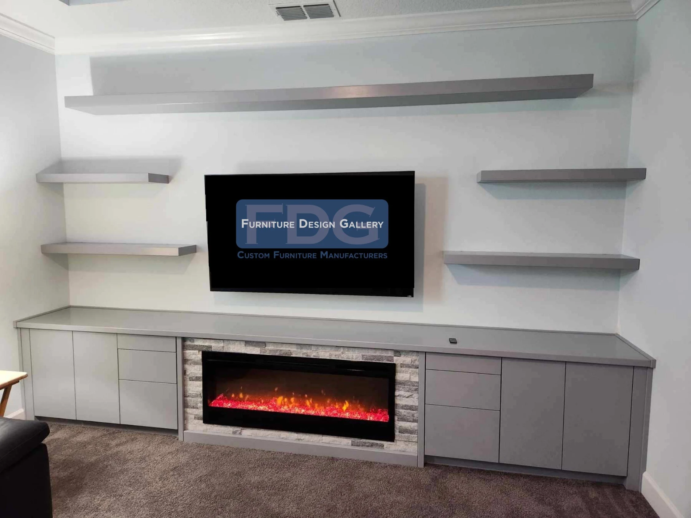 48. Sleek, modern, and built to blend. This custom entertainment center pairs a seamless gray console and integrated fireplace with minimalist floating shelves for a perfectly balanced living space.