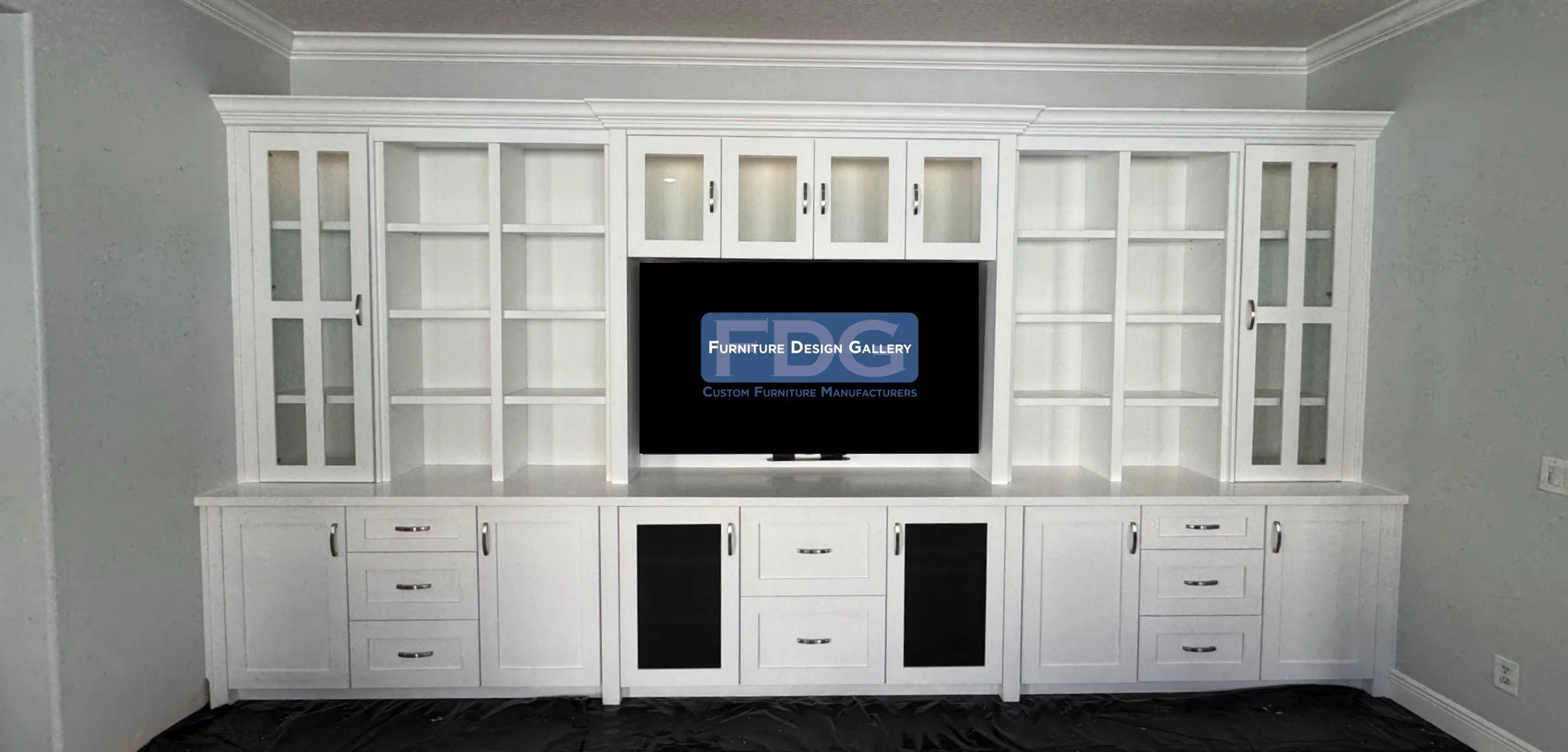 7. Grand in scale and detail. This expansive custom wall unit features a mix of glass-front cabinetry, open shelving, and integrated drawer storage, all finished in a crisp white for a polished, traditional look.