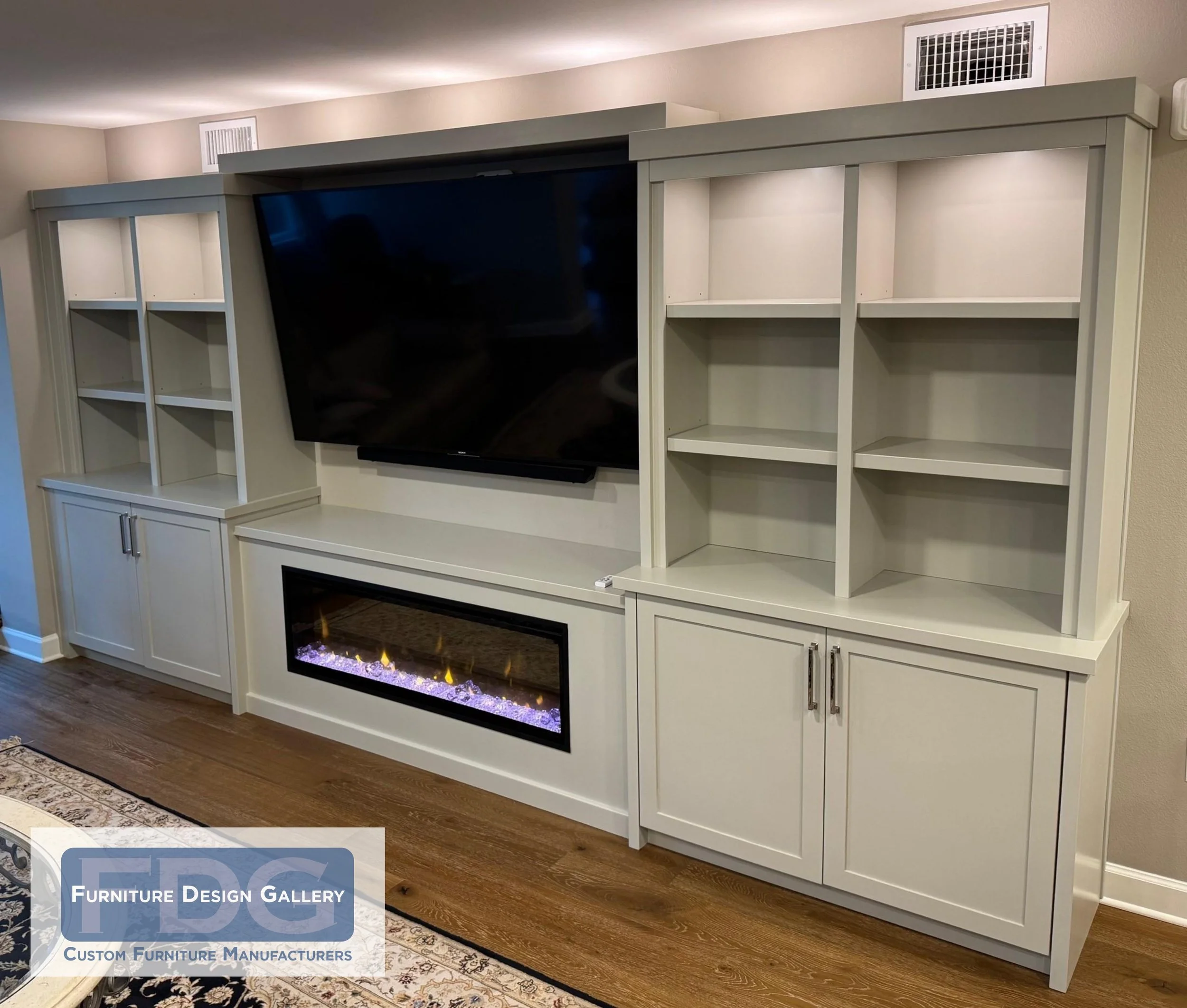 39. Sleek, transitional, and functional. This custom painted wall unit anchors the room with a built-in electric fireplace, integrated display lighting, and clean-lined cabinetry for a polished, modern look.