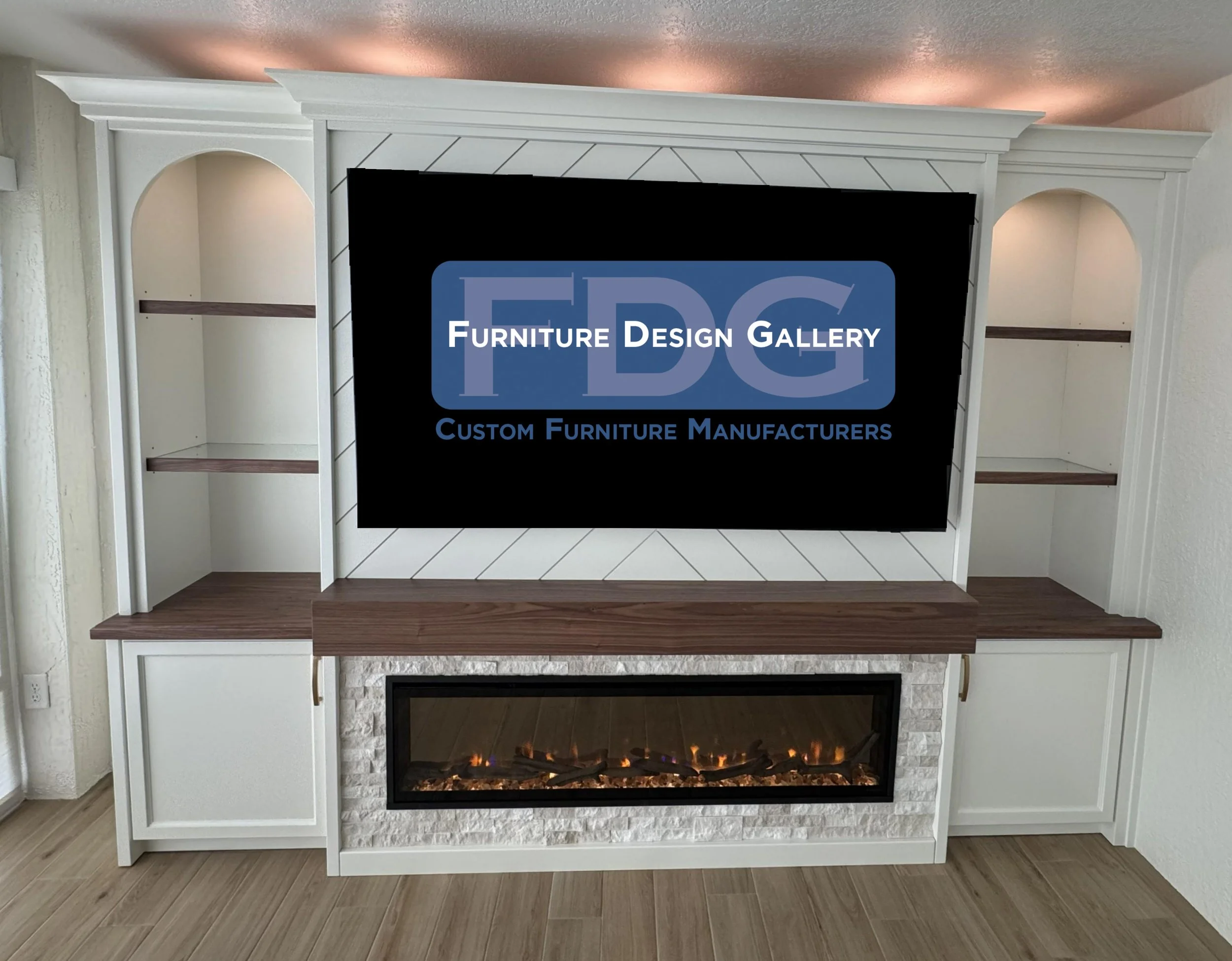 77.  Bring warmth and style to your living room with a custom entertainment center designed to fit your home perfectly. This elegant white unit features a striking chevron backdrop, elegant arched shelving, a stacked stone fireplace surround, and ric