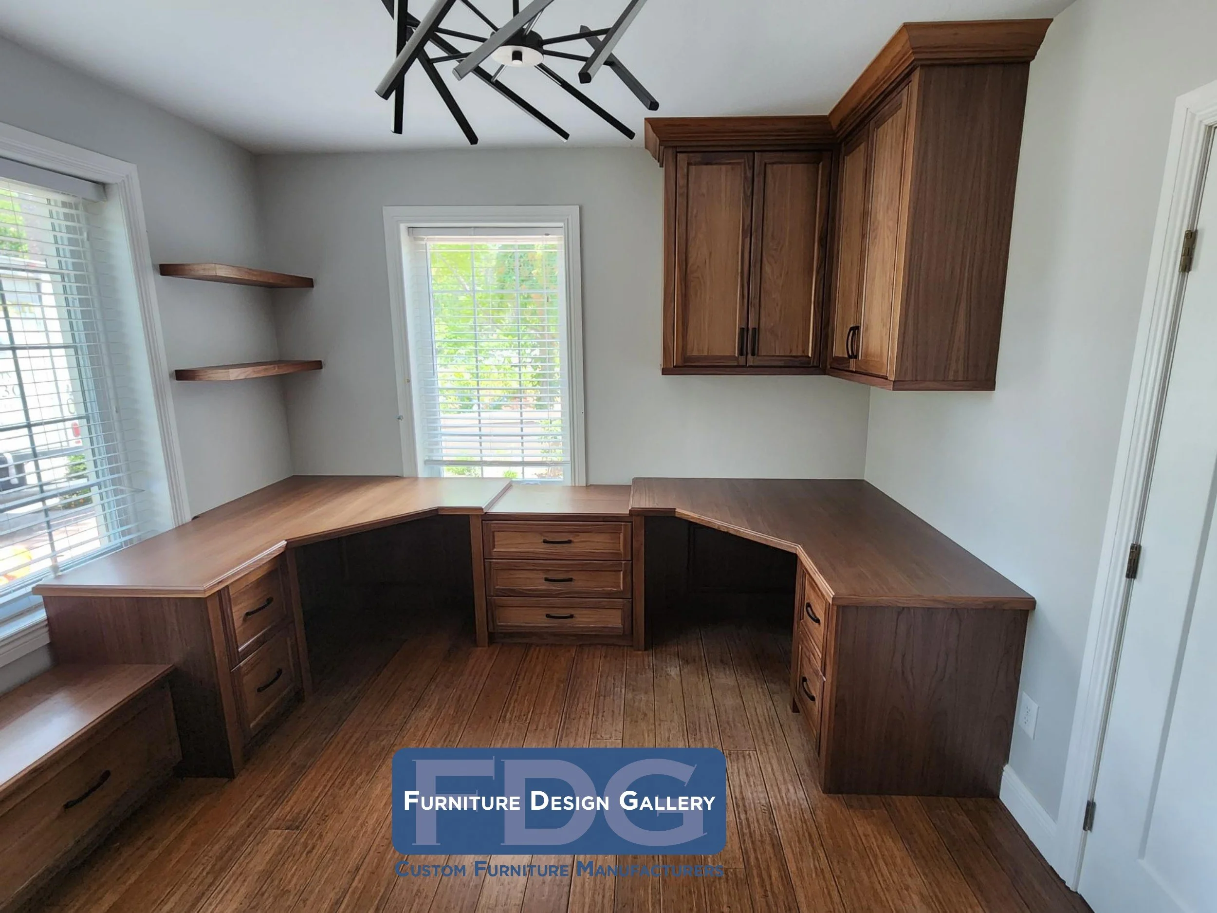 6. This sophisticated walnut home office maximizes productivity with a sprawling custom wrap-around desk, matching upper cabinetry, and sleek floating shelves.