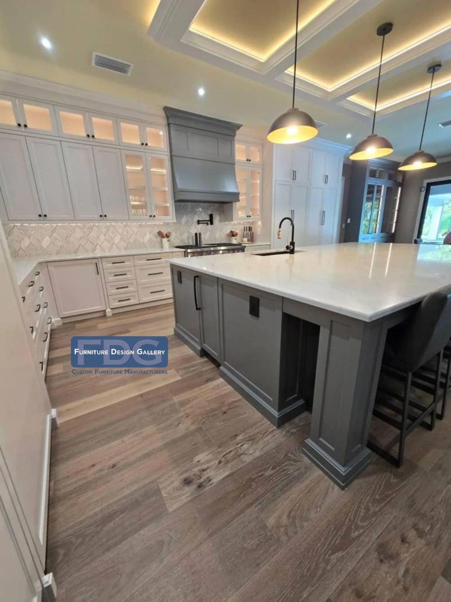 7.  Detailed view of bespoke kitchen cabinetry, custom hood enclosure, and coffered ceiling accent lighting.