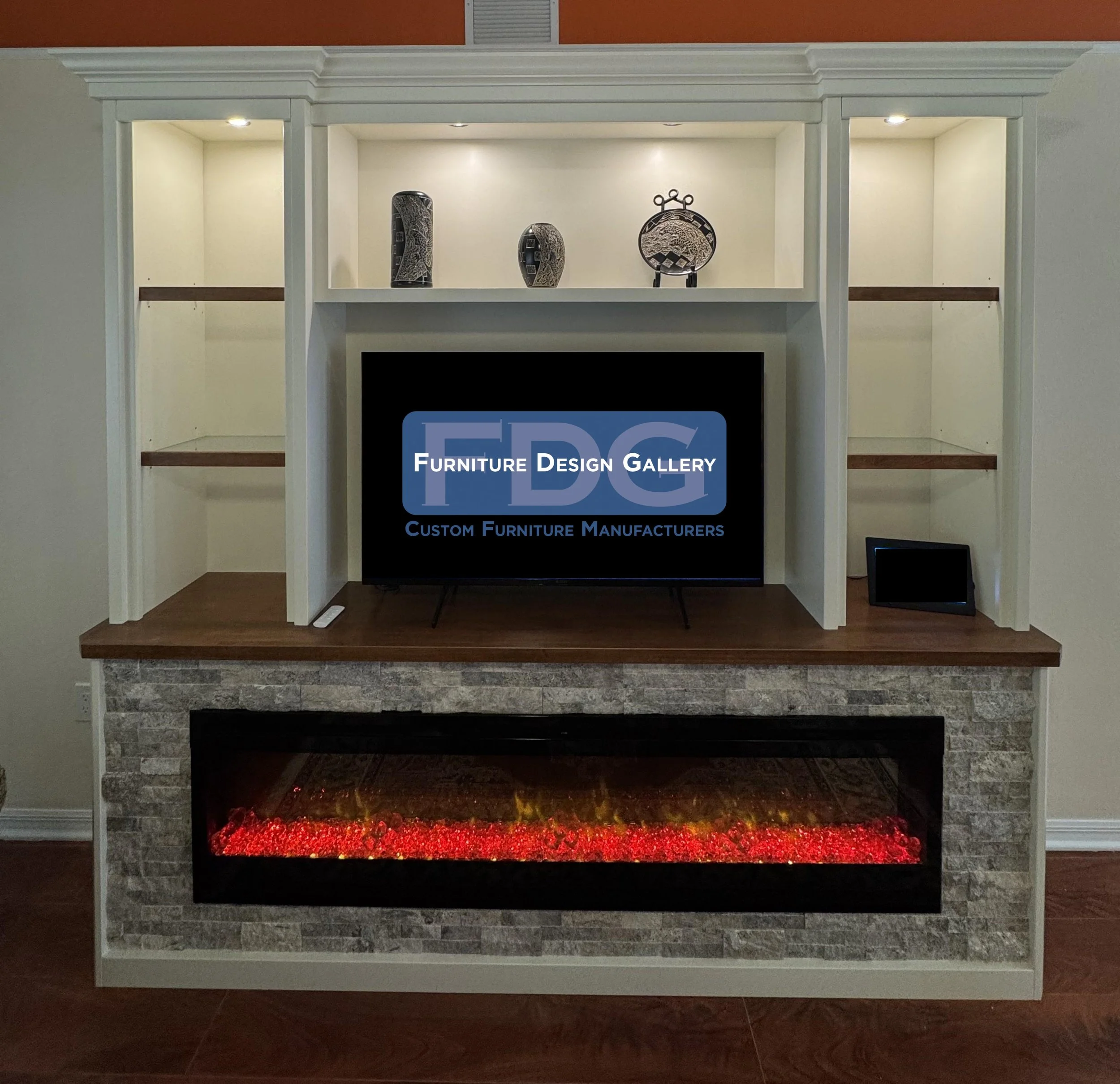 55. Cozy nights and modern design. 🔥 This custom entertainment center features a built-in fireplace, stone accents, and integrated lighting to create the ultimate living room focal point.
