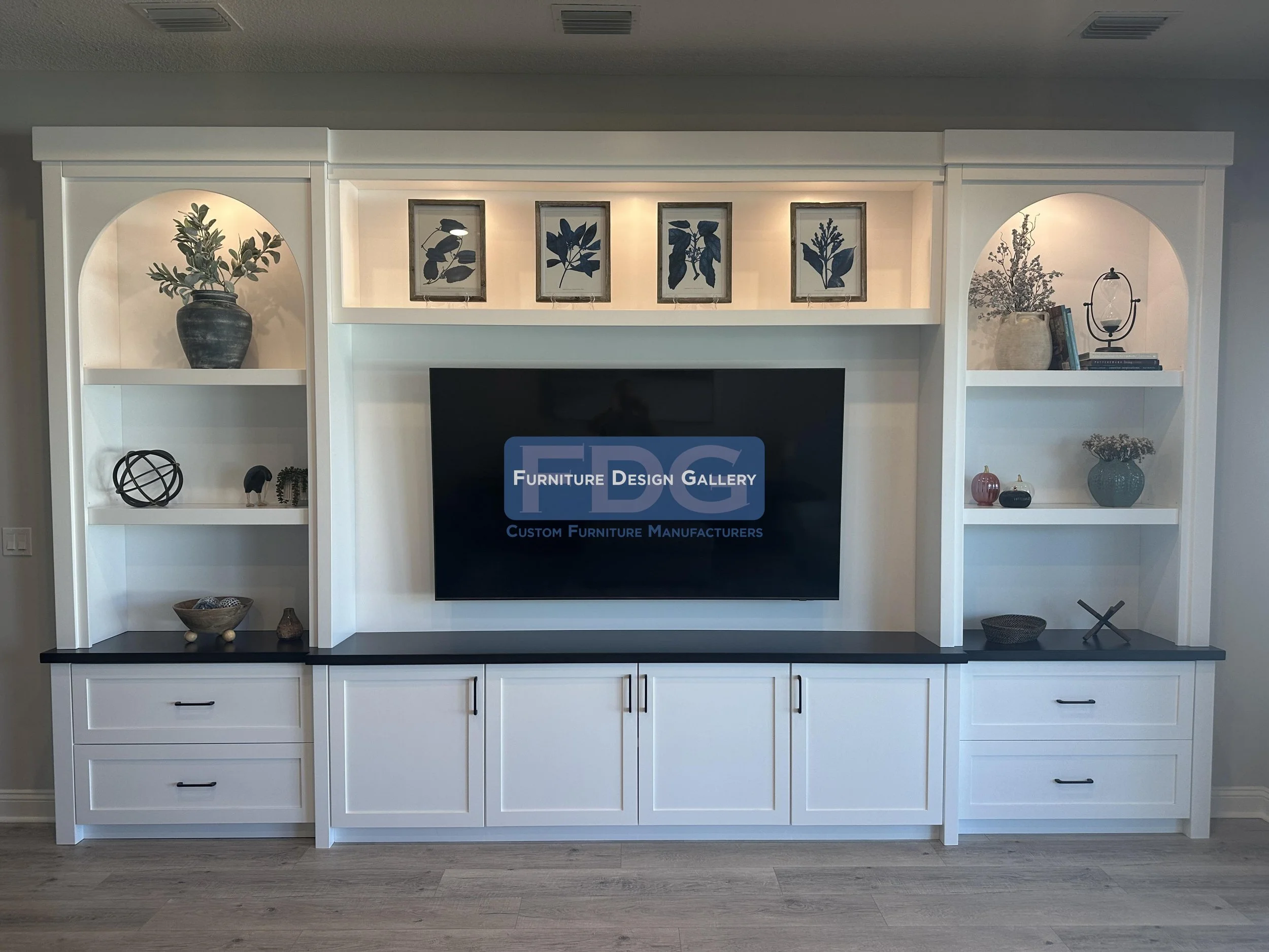 34. Timeless arched details and bold black countertops create a striking contrast in this custom built-in. A perfect blend of architectural interest and practical storage.