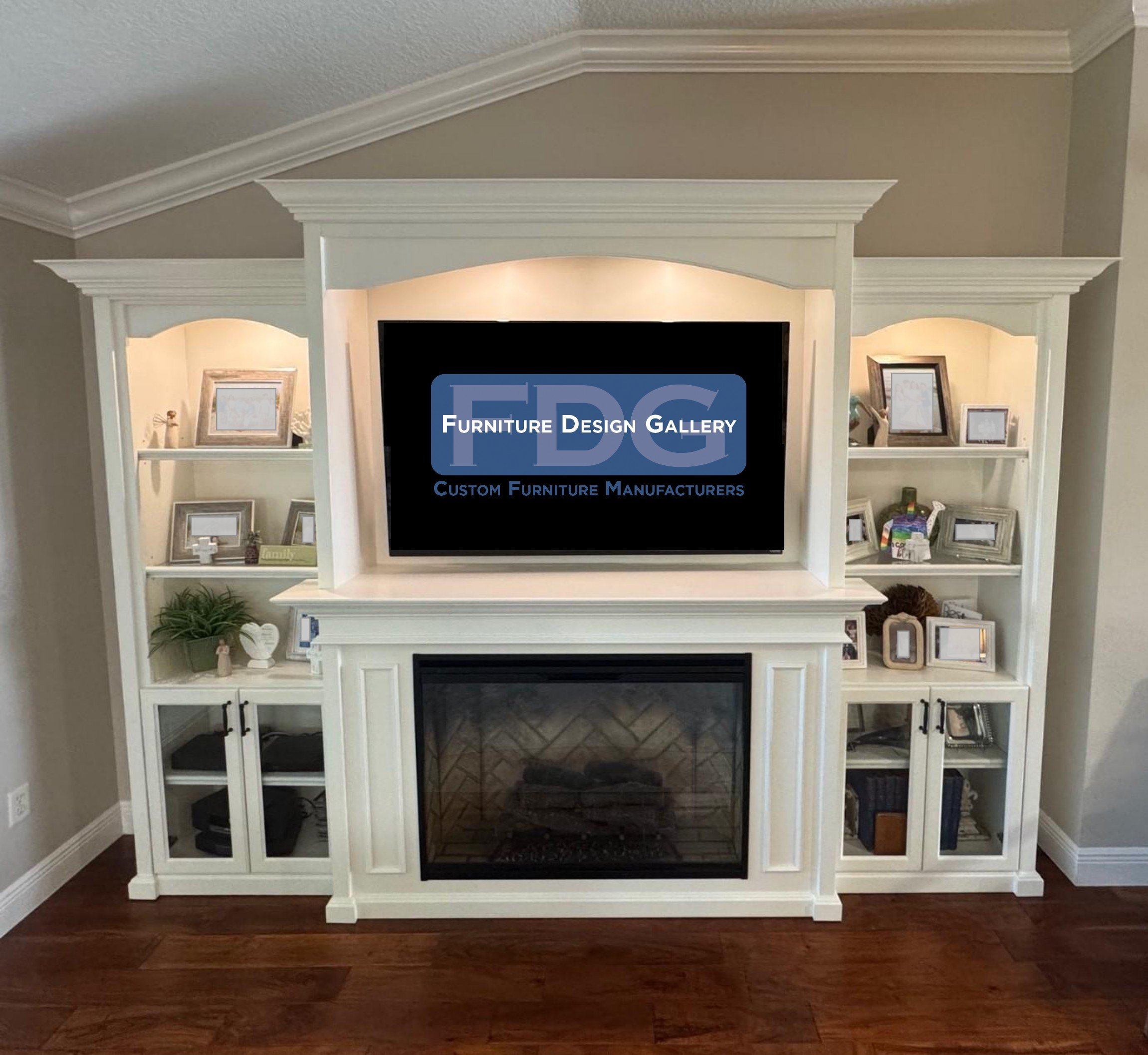 8. Classic sophistication meets home comfort. This custom white wall unit features elegant crown molding and soft arched detailing, beautifully framing a traditional hearth for a warm, timeless living space.