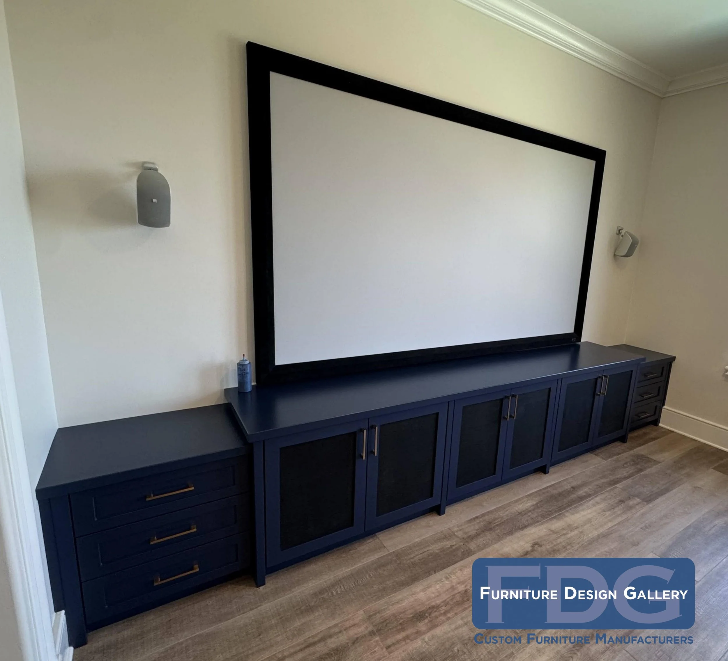 63. This custom low-profile media console featuring clean lines, elegant gold hardware, and mesh-front doors for seamless tech integration, it’s the perfect foundation for a home theater experience.