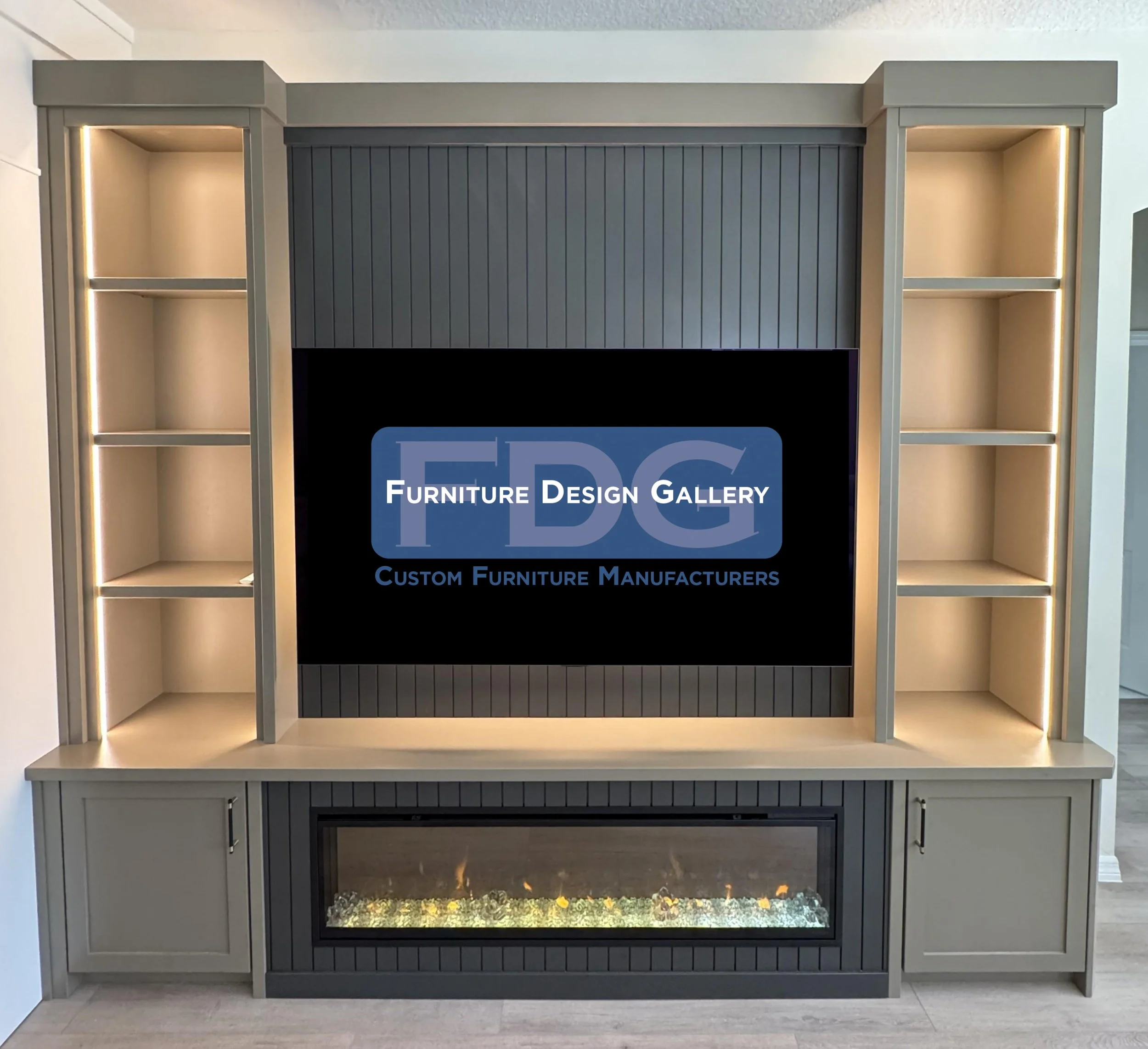 76.  Elevate your home entertainment with a sleek custom media center. This design features a moody, dark vertical slat backdrop, clean taupe cabinetry, integrated strip lighting to showcase your decor, and a built-in linear fireplace.