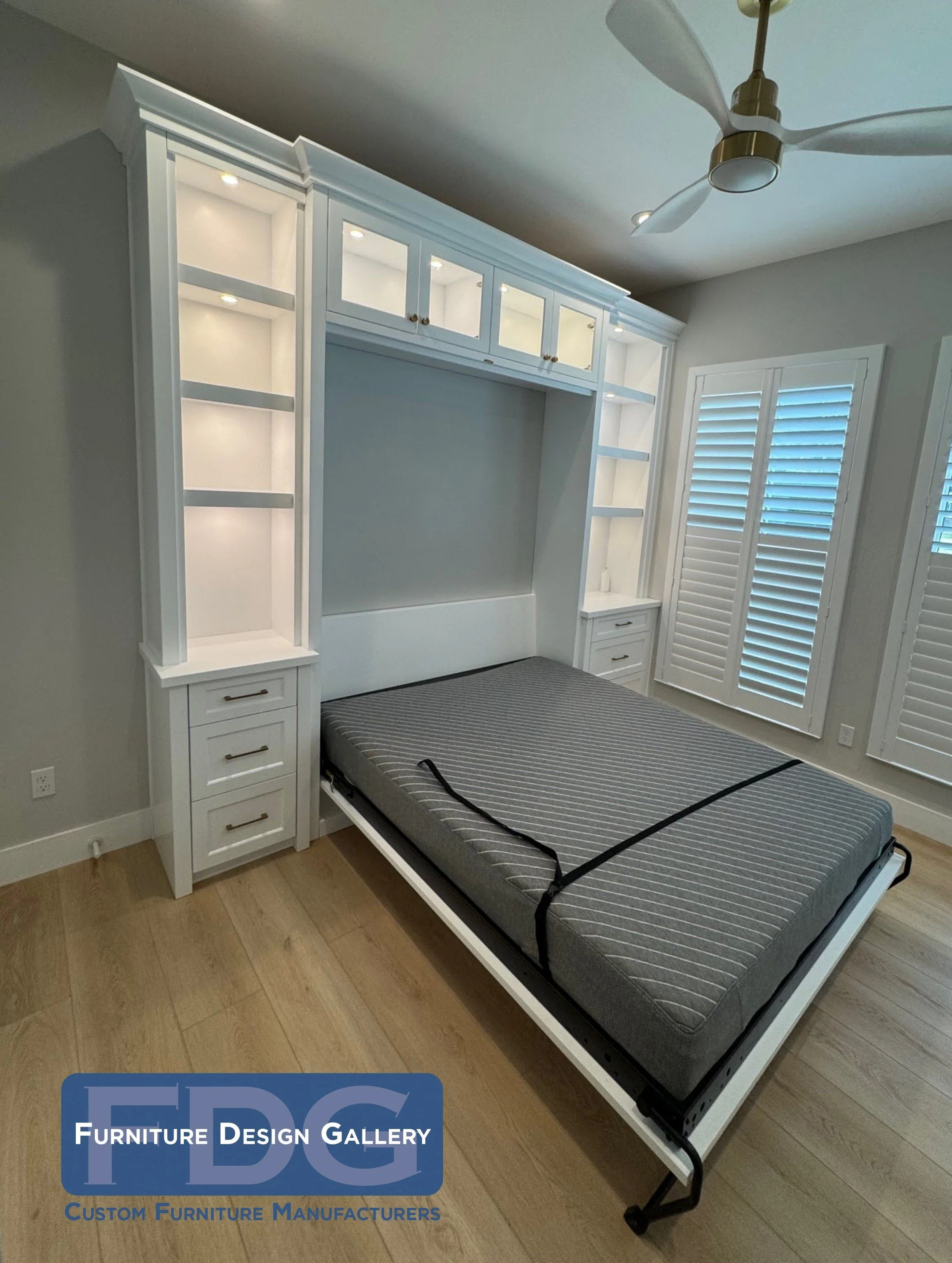 8. Maximize your guest room's potential with this sophisticated white Murphy bed, featuring illuminated display shelving, integrated bedside drawers, and elegant glass-front upper cabinets.