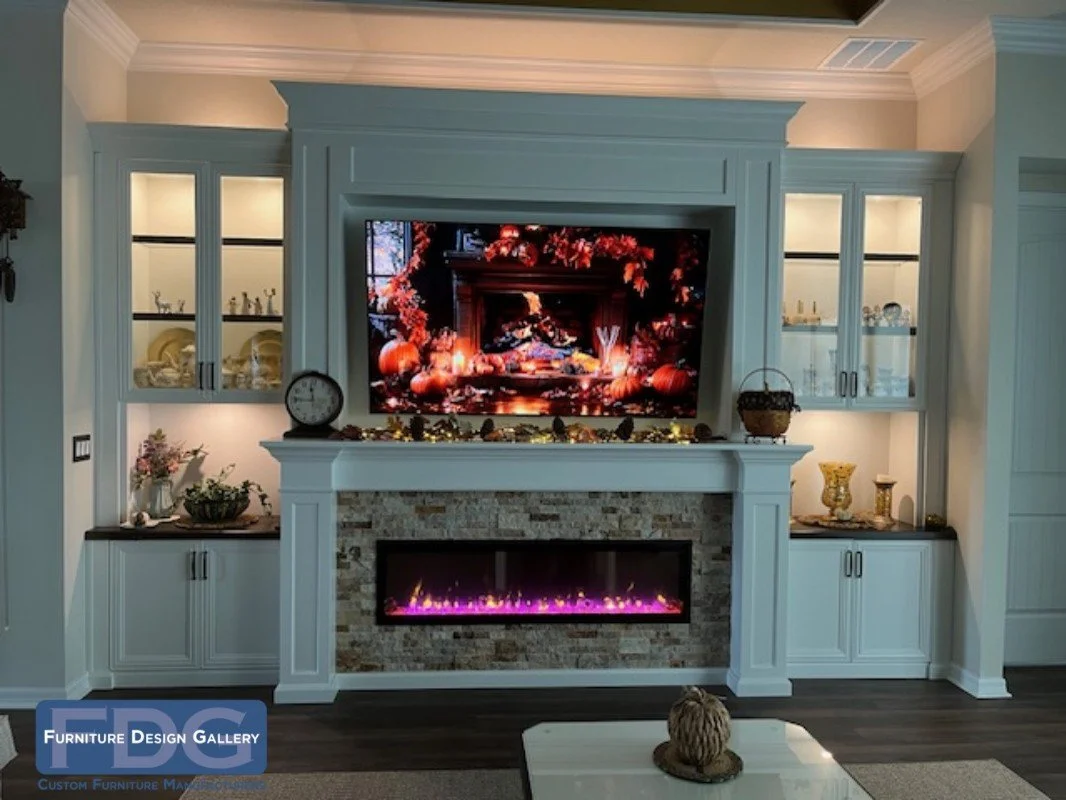 42. Grand and inviting. This custom white wall unit features a stunning stacked-stone fireplace, illuminated glass-front cabinetry, and a tiered mantel design that creates a warm, sophisticated center for any home.