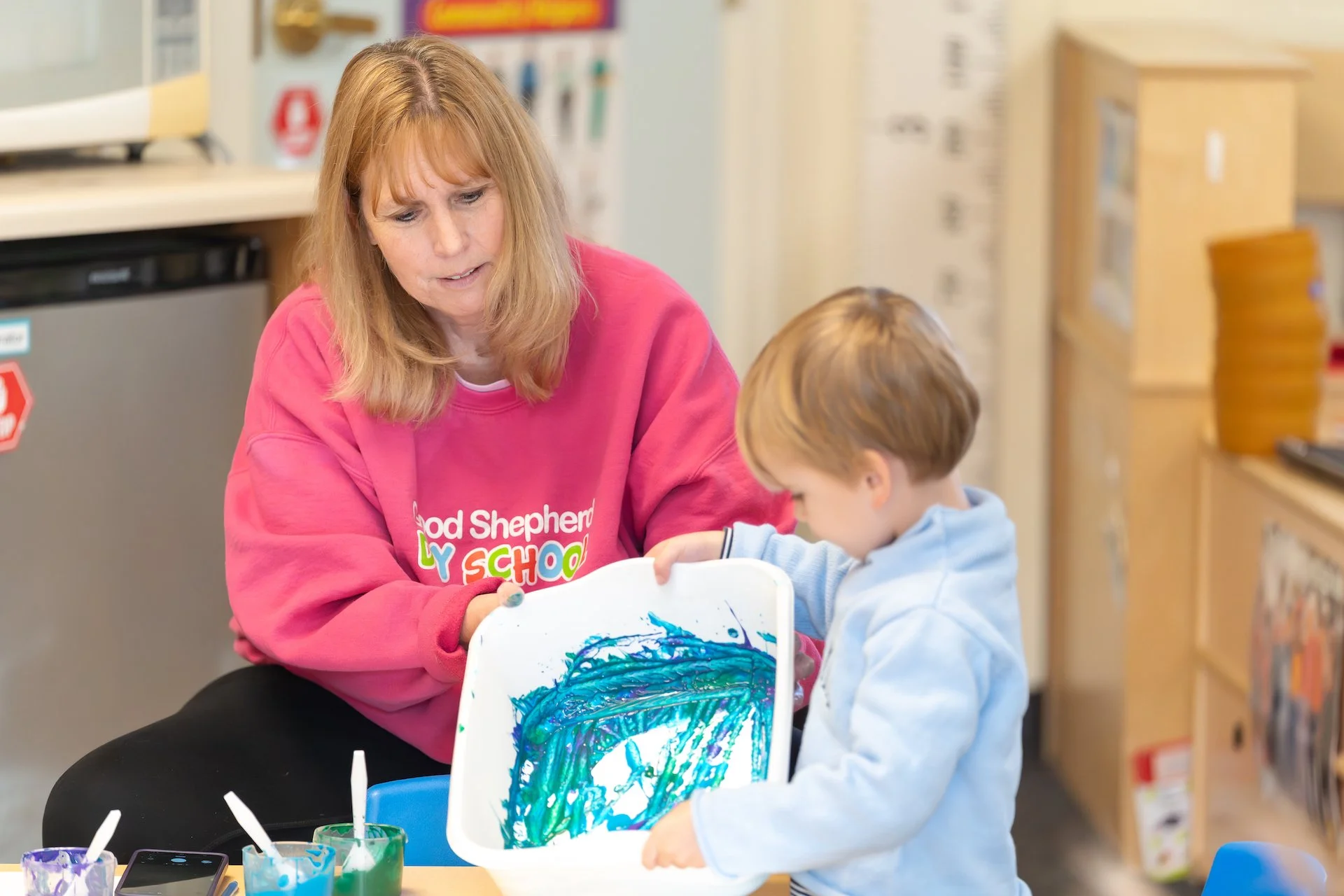 A woman in a pink sweatshirt with