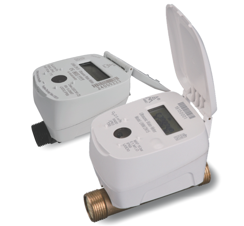 Digital water meters with open lids, one with a display screen and the other with a barcode, connected to copper piping.