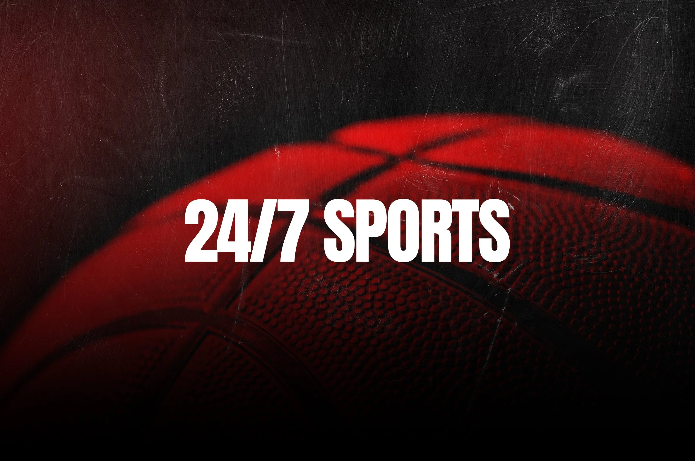 Close-up of an orange basketball with the text 24/7 SPORTS in white, overlaid on the ball, with black background.