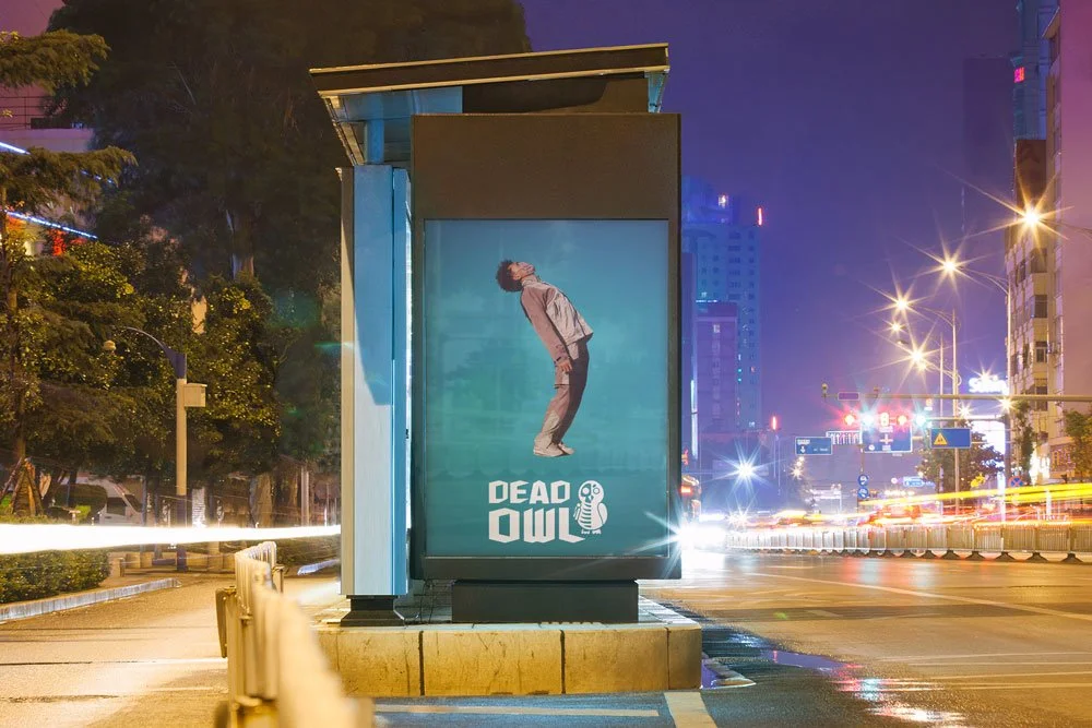 Dead Owl large logo white, blue background and model in background, street poster mockup.