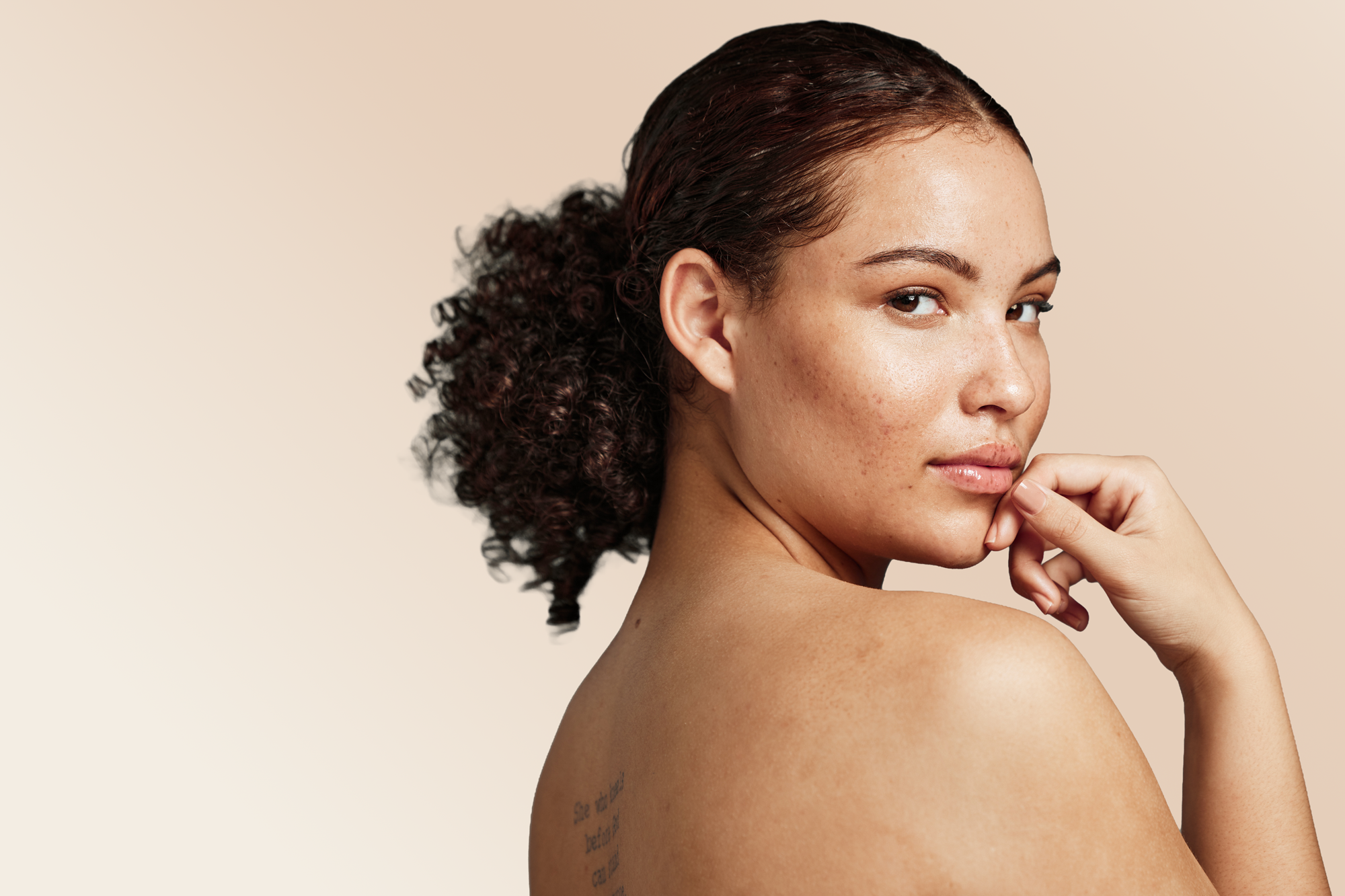 Latina-woman-back-tattoo-words.png