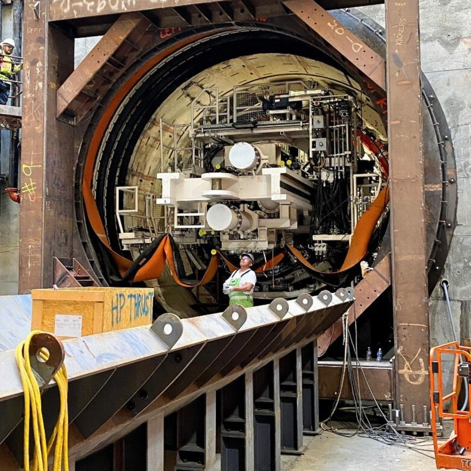 Tunnel boring machine pushing off a steel frame to begin tunneling.