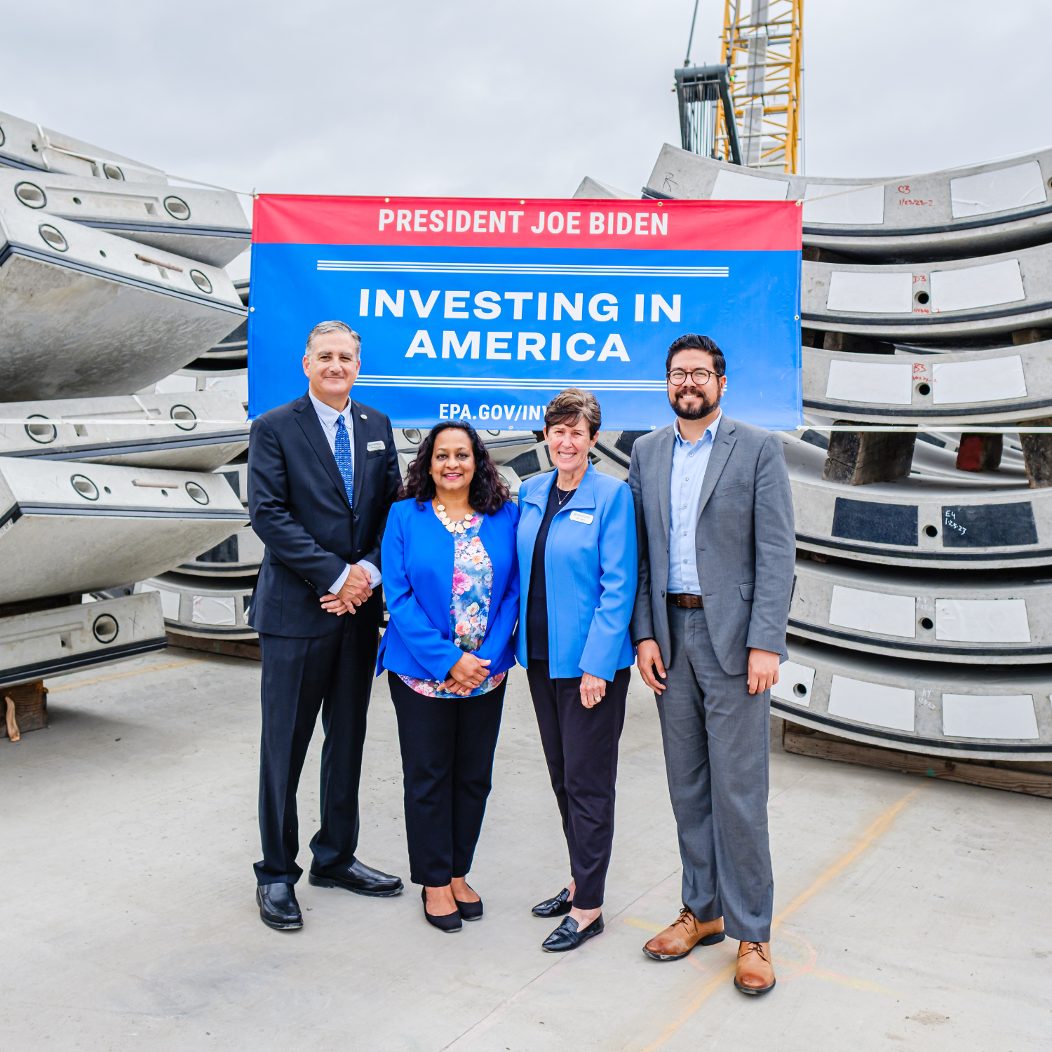 EPA Assistant Administrator Radhika Fox, LA County Sanitation Districts Chairwoman Cathy Warner, and State Water Resources Control Board Chairman Joaquin Esquivel stand in front of tunnel ring segments during a visit to the Clearwater Project site.