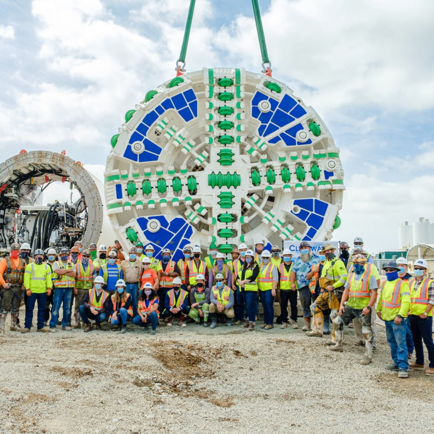 Contractor’s mining crew stands in front of the tunnel boring machine.