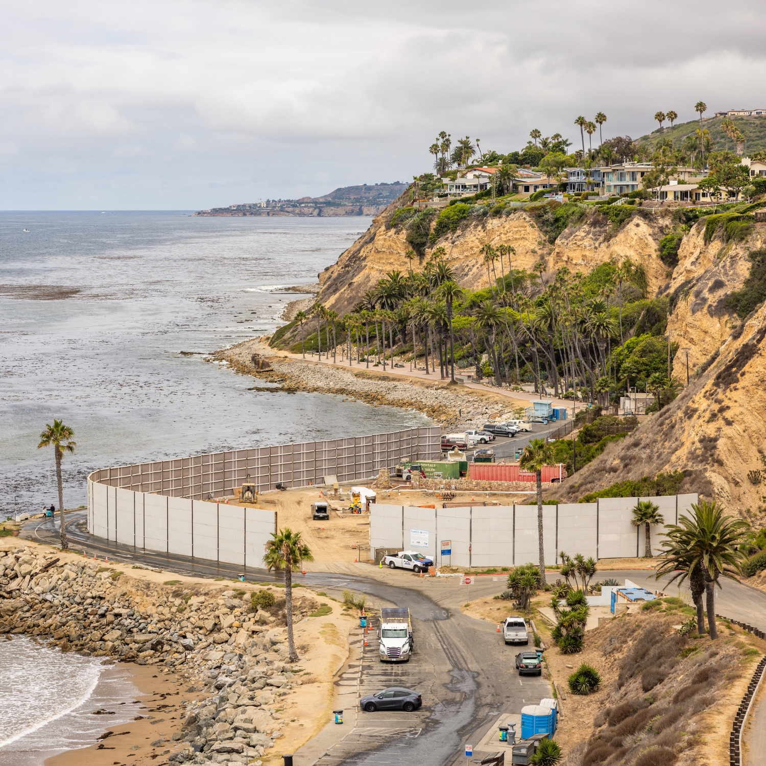 A view of the sound wall around the construction site at Royal Palms Beach