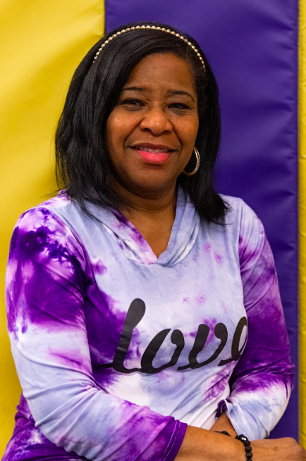A light bulb with a yellow top and a fabric-covered base, set against a blue background.