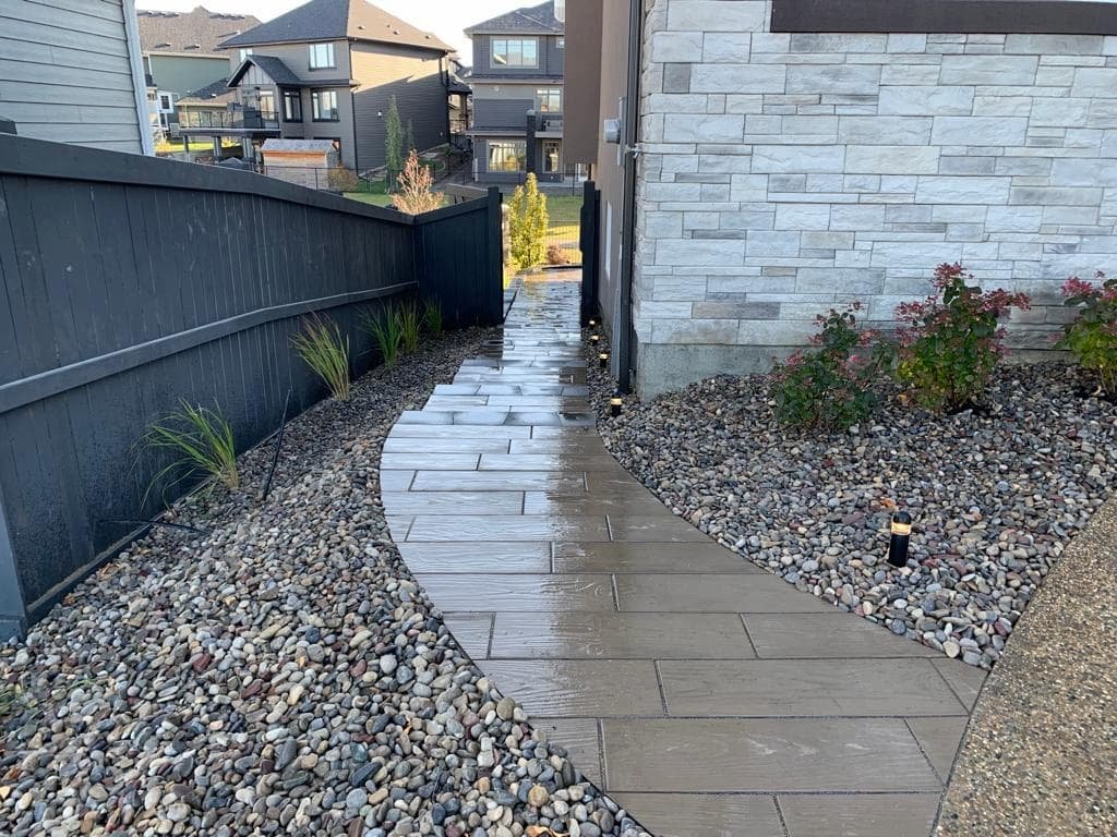 Brickstack custom walkway with river rock surround