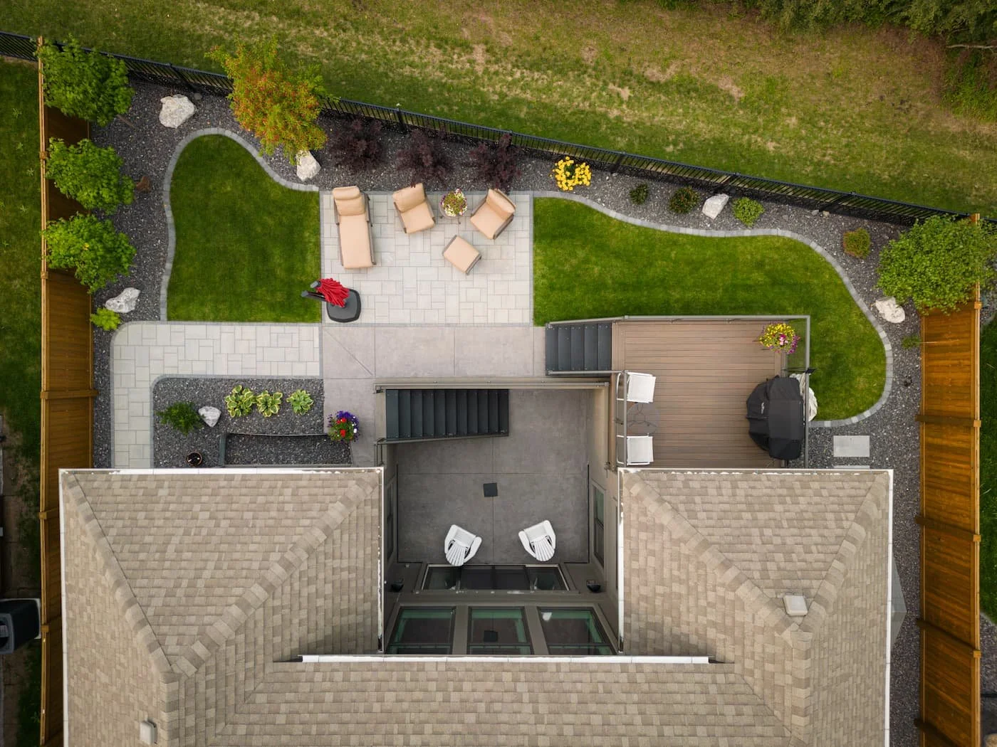 Birds eye view showing a backyard patio, walkway, landscaping and sod