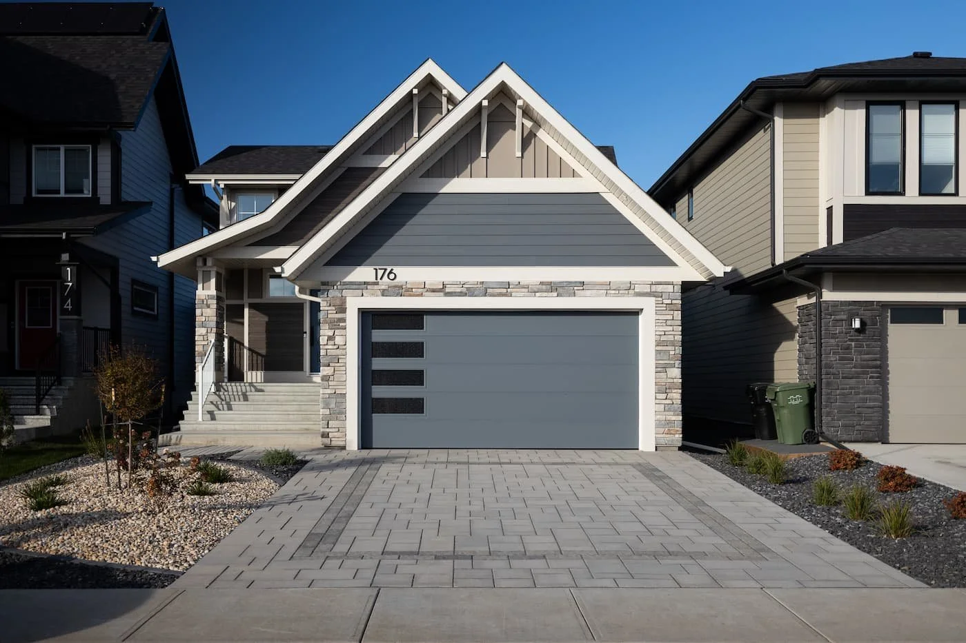Beautiful driveway built with modern paving stones with a textured inlay detail