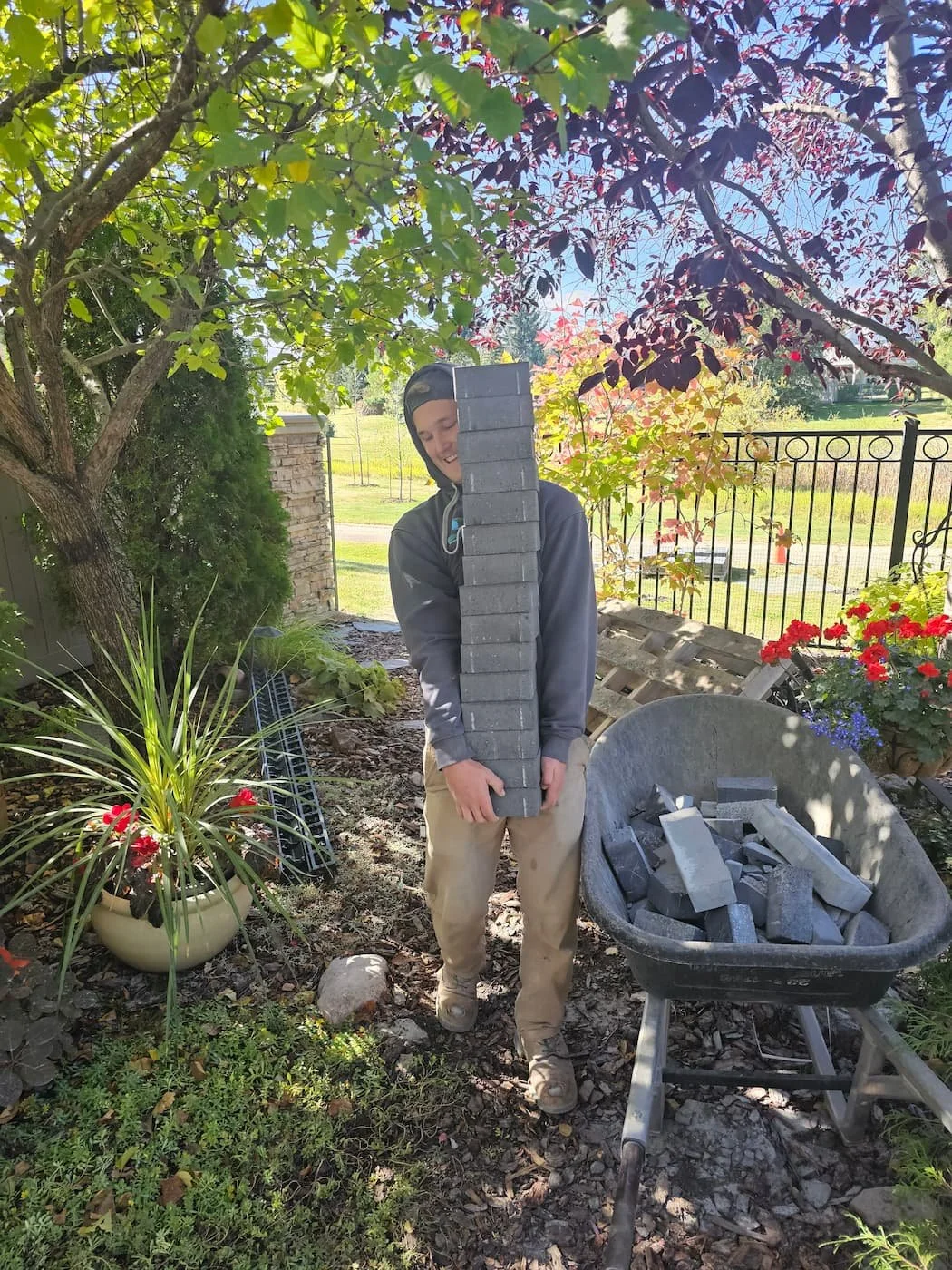 Carrying a large stack of paving stones