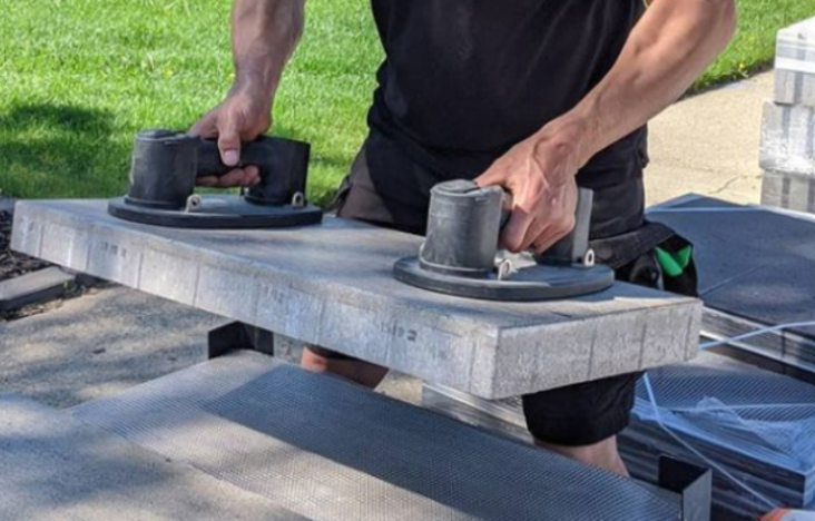 Paving Stones being lifted for patio installation