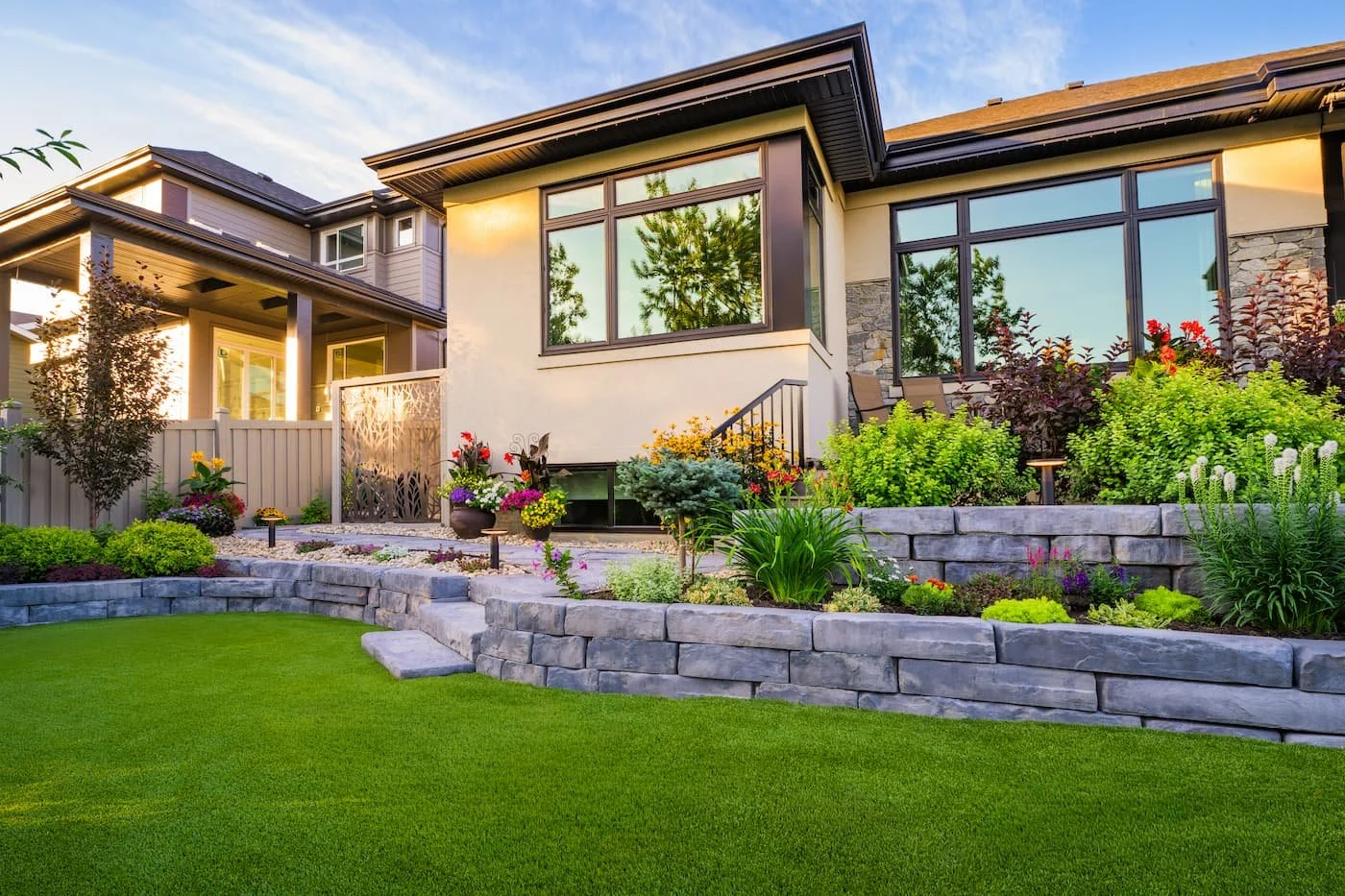 Backyard using a retaining wall to create multiple levels and garden boxes