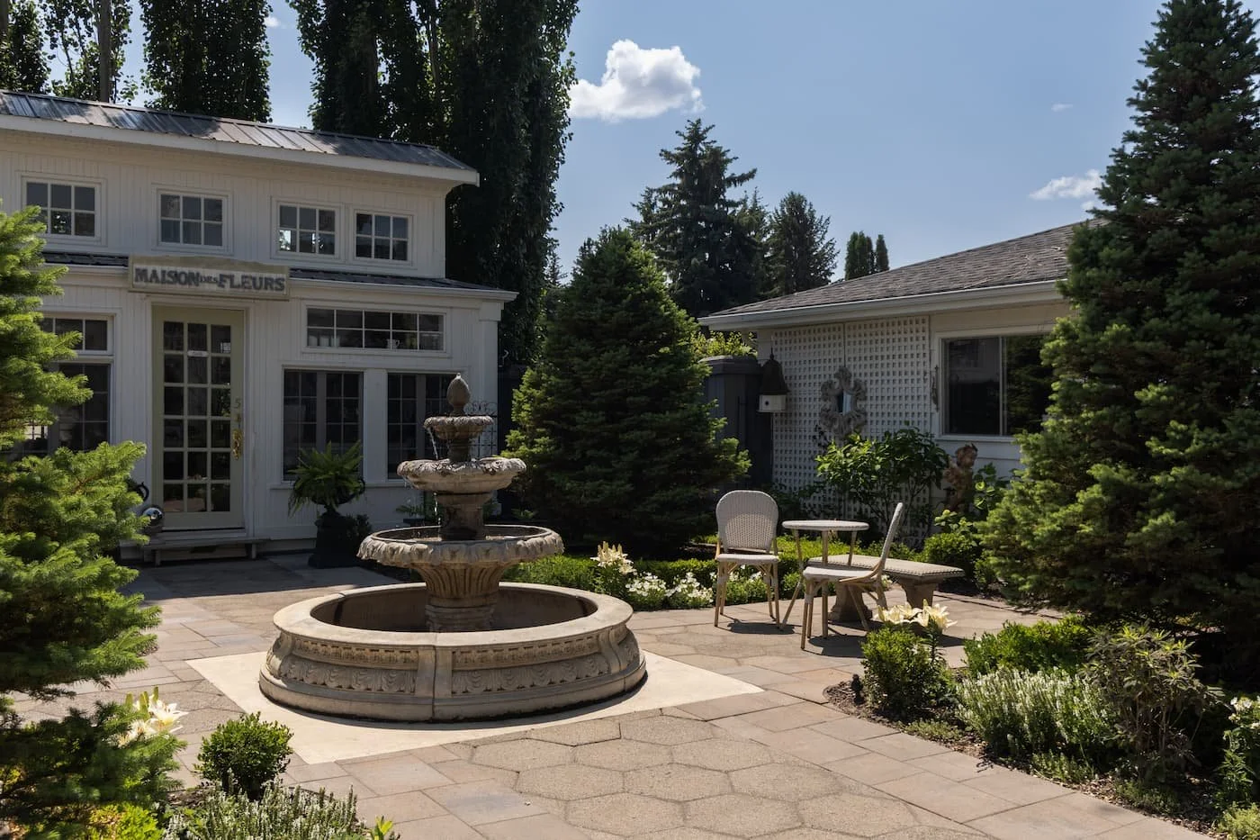 Feminie european inspired garden with paving stones, water feature and bistro seating