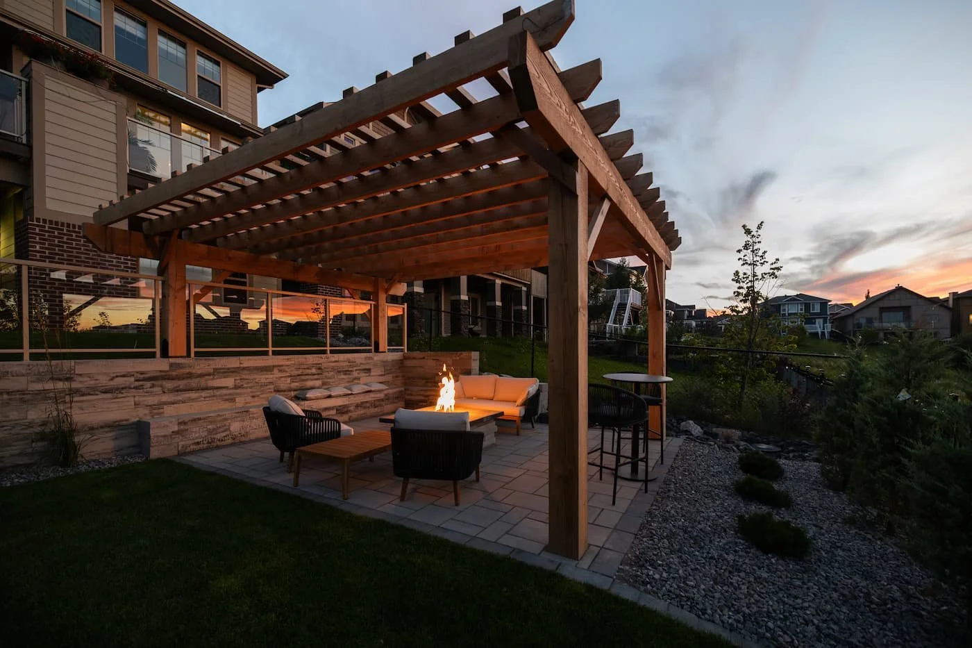 Hardscaped backyard with a firepit during a sunset