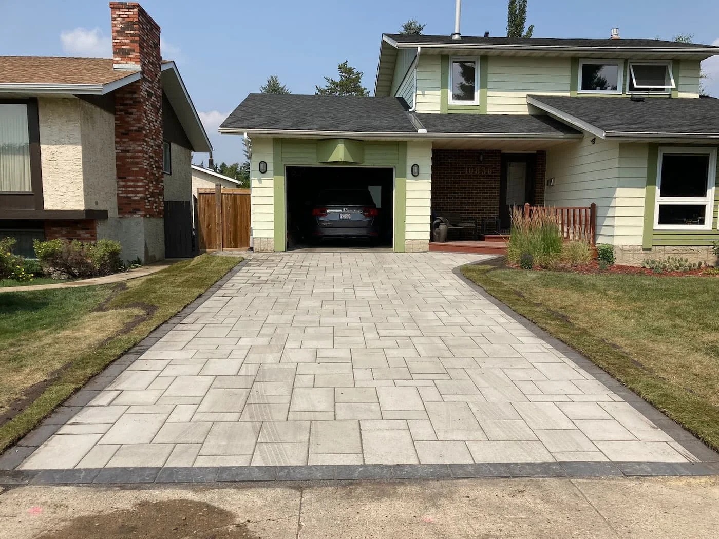 Custom smooth paving stone driveway with border detail in onyx black