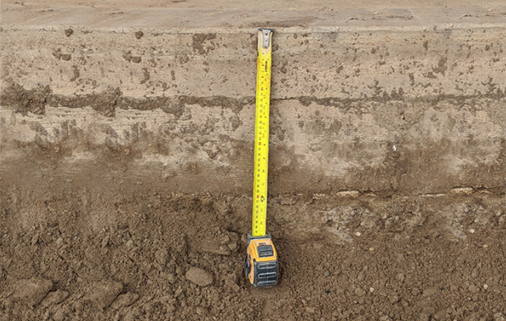 Tape measure showing 10'' depth for patio base