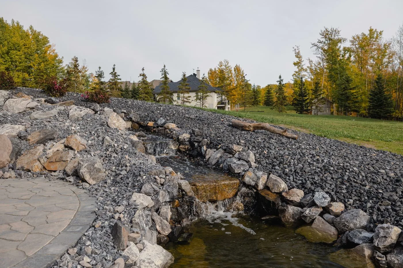 Pondless  water feature  surrounded by rundle rock