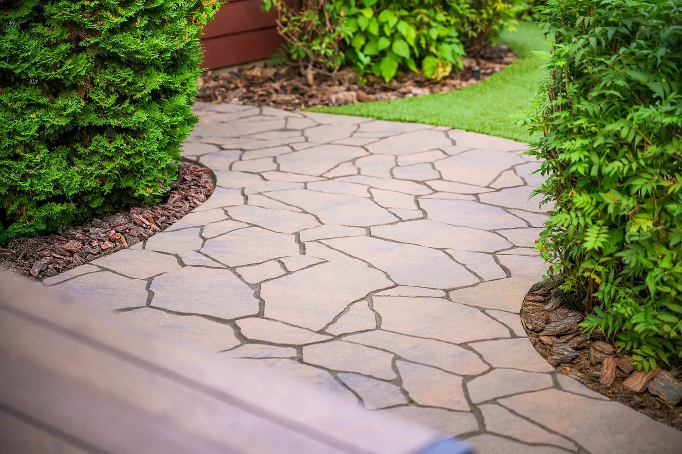Mega Libre patio with natural edges leading into a landscaped backyard