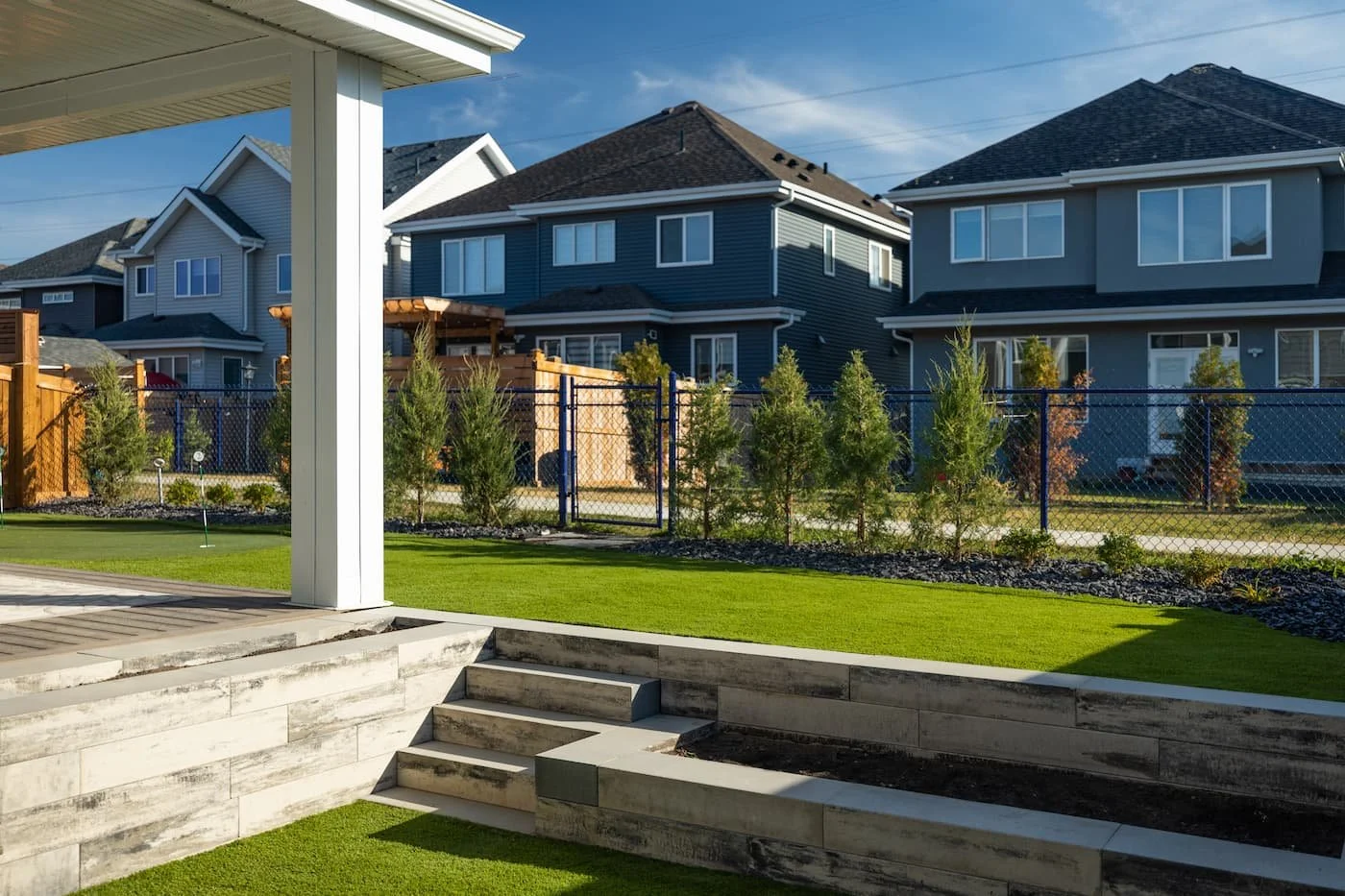 Multilevel backyard with retaining wall, steps and a garden wall in Sterling Grey