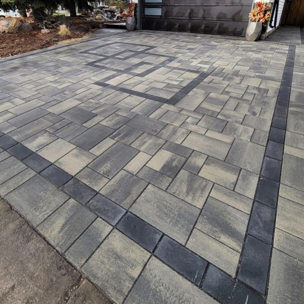 Artistic and innovative paving stone driveway with a inlay retail in Shale Grey