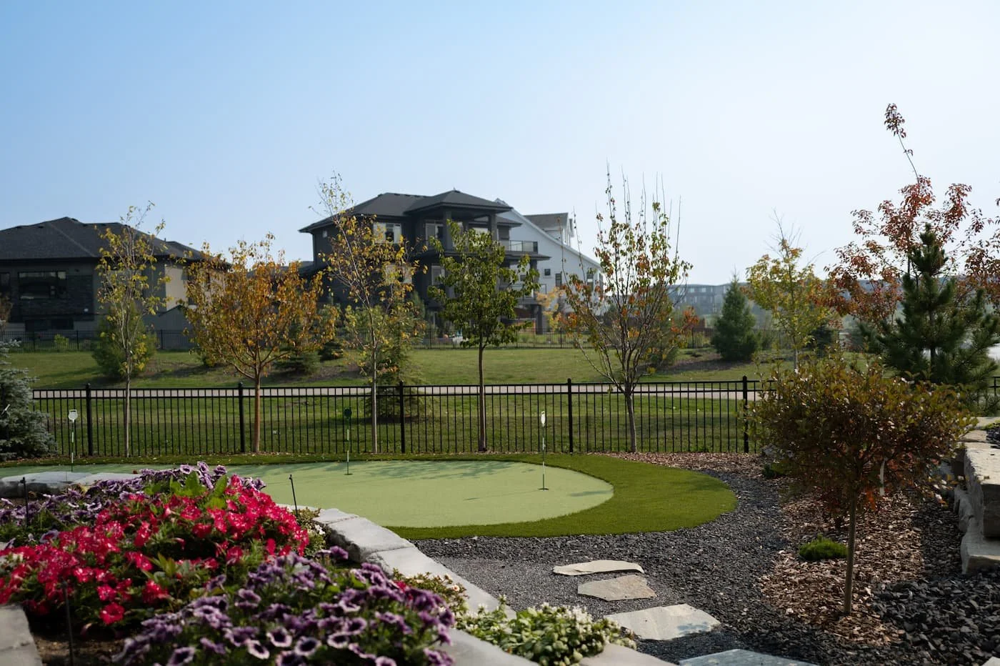 Backyard putting green with stepping stones and petunias