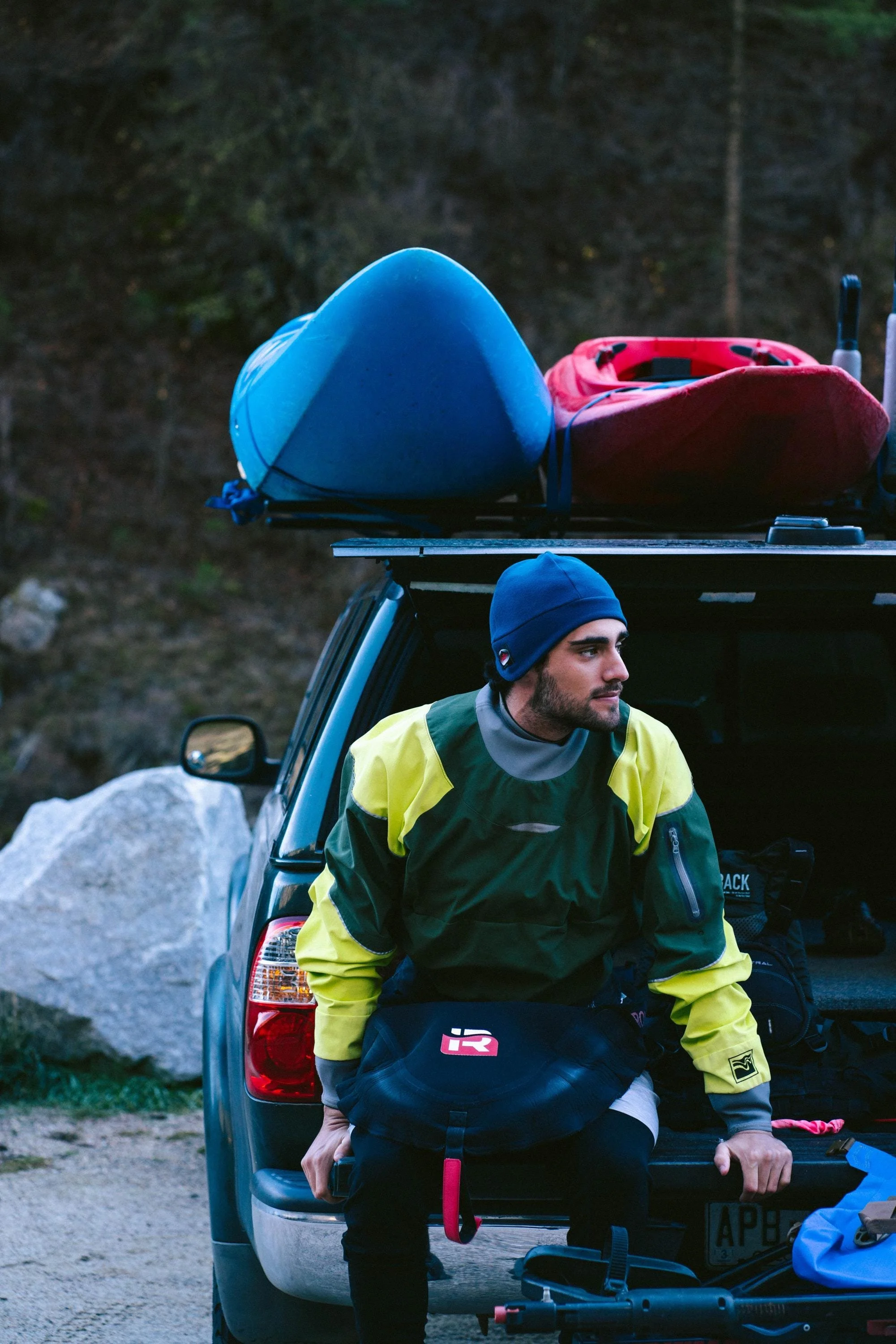 A man wearing a hat waiting to go kayaking.