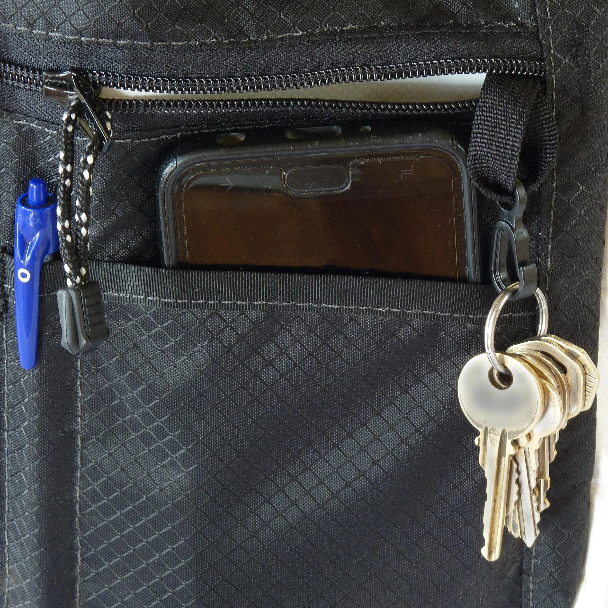 Close-up view of a black nylon crossbody bag's interior pocket.