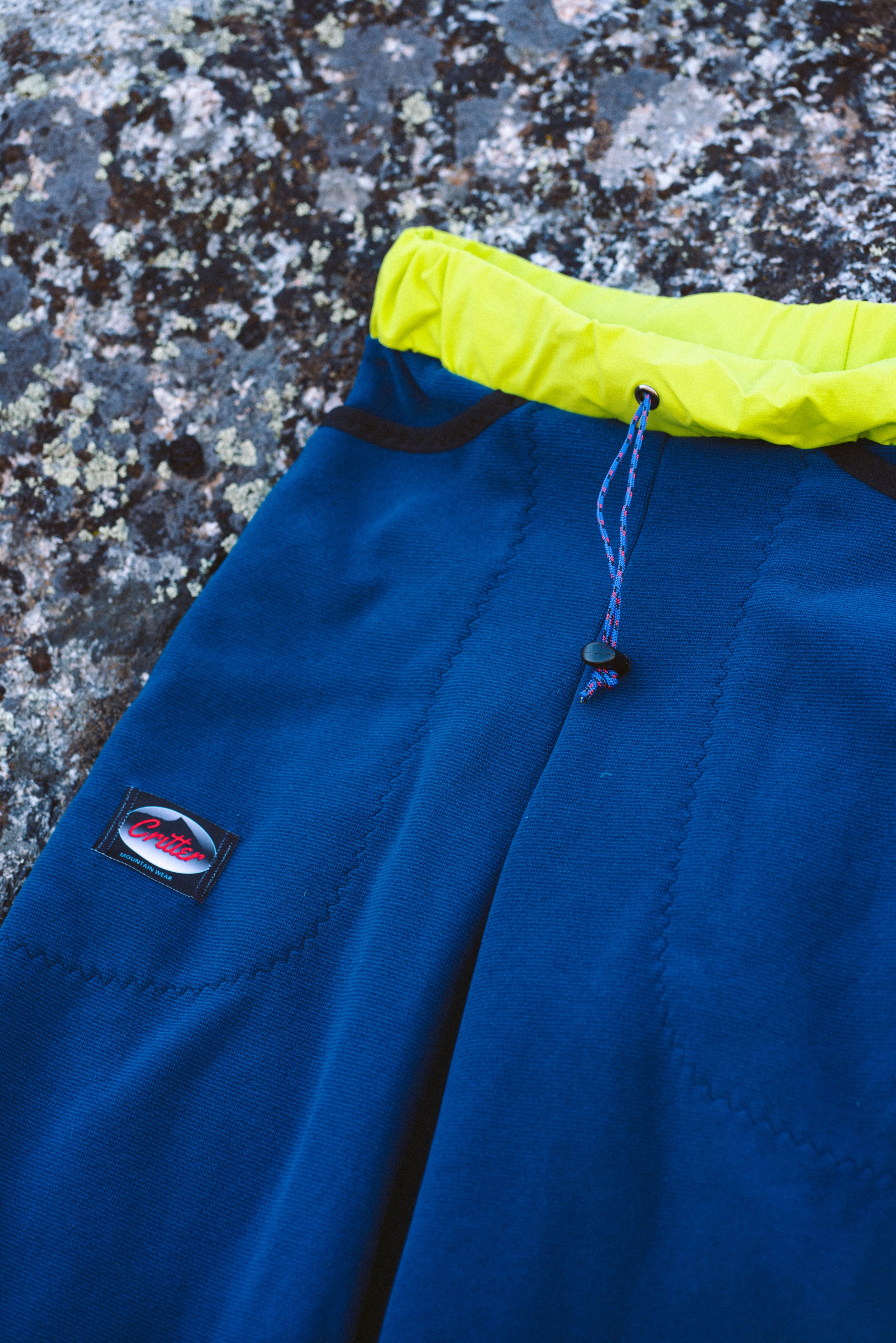 The front of a pair of Polartec Critter Pants showing the waistband and drawcord.