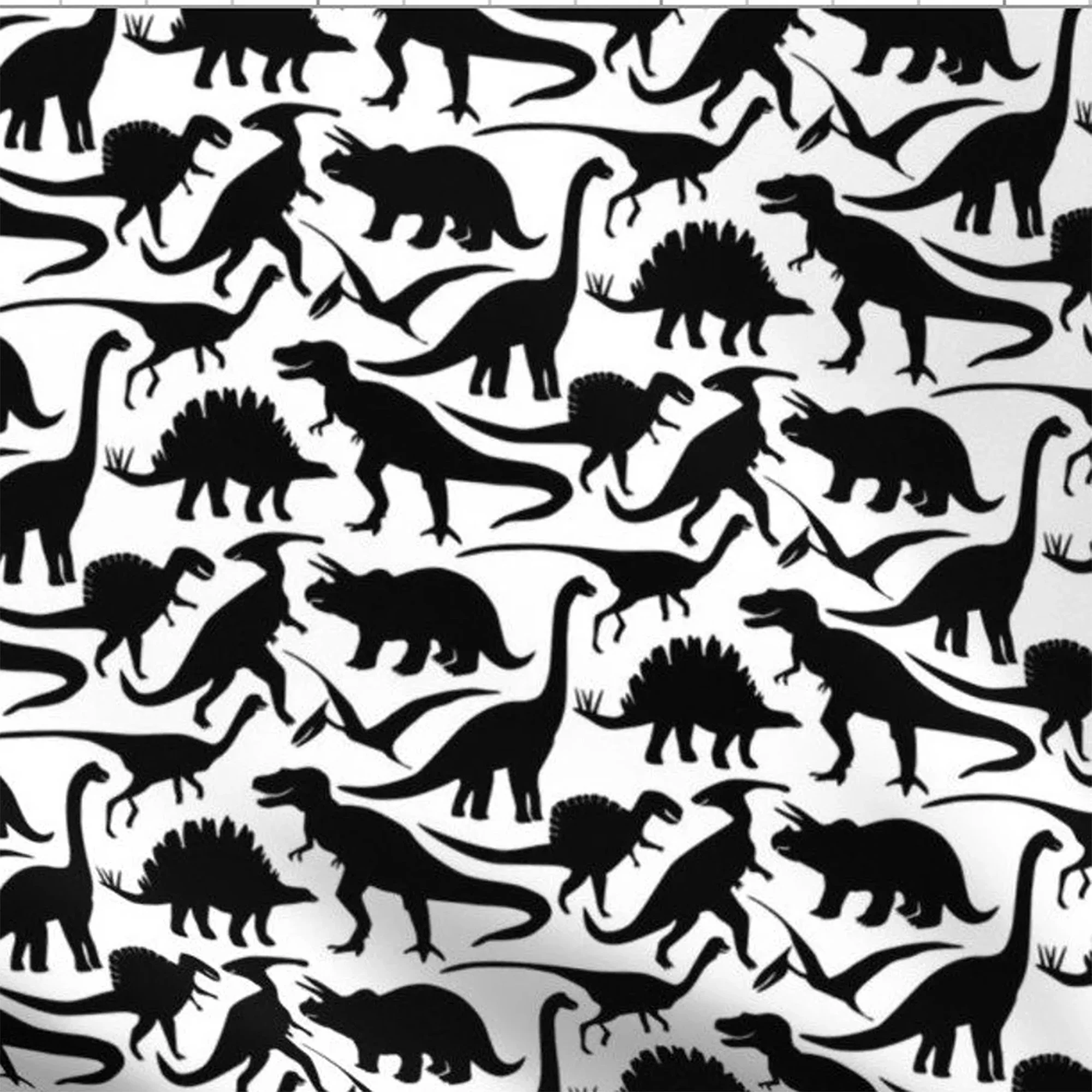 A white fabric with black dinosaur bone silohuettes. The fabric is used on the front of the messenger bags.