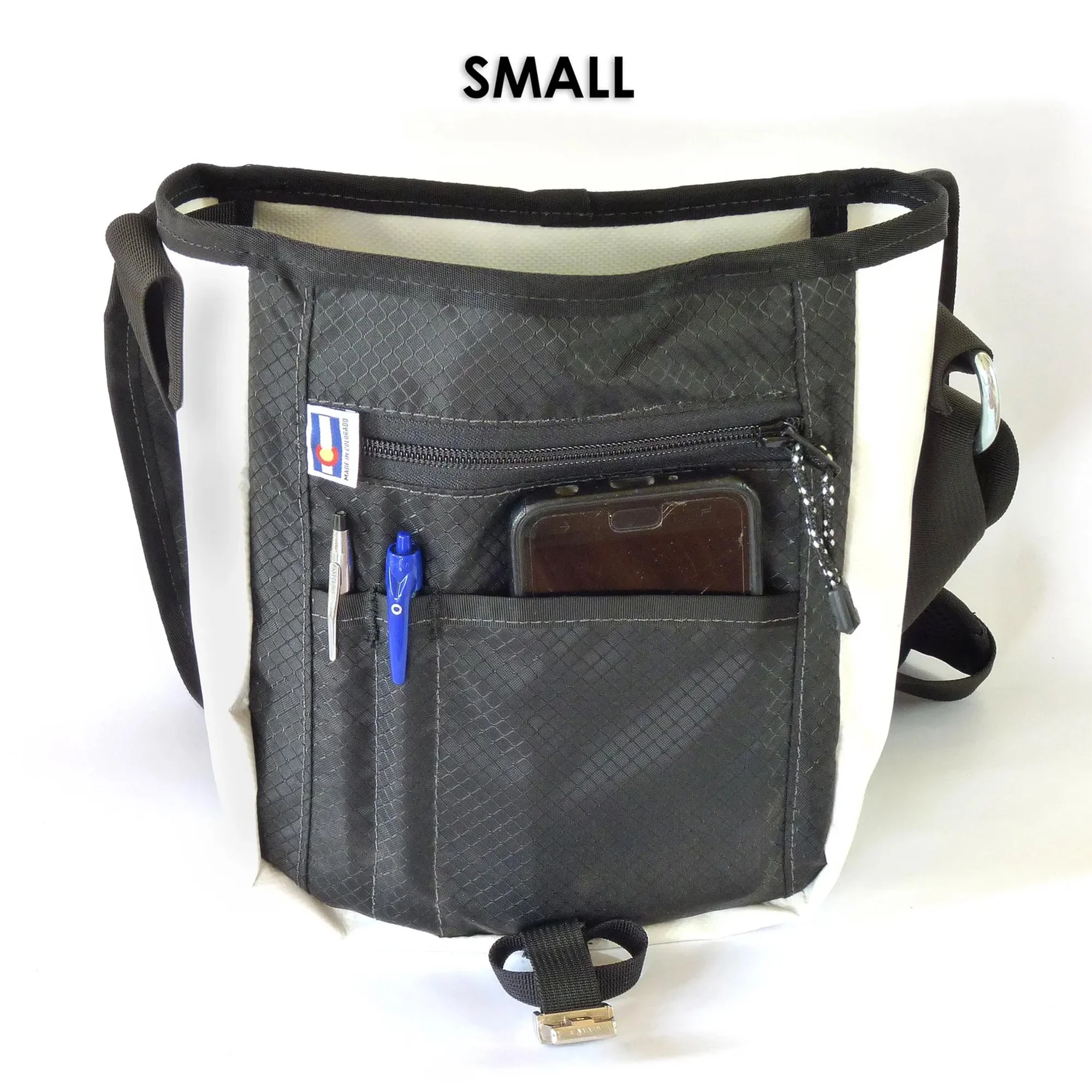 Small white canvas messenger bag with a black nylon interior. The bag features multiple pockets.
