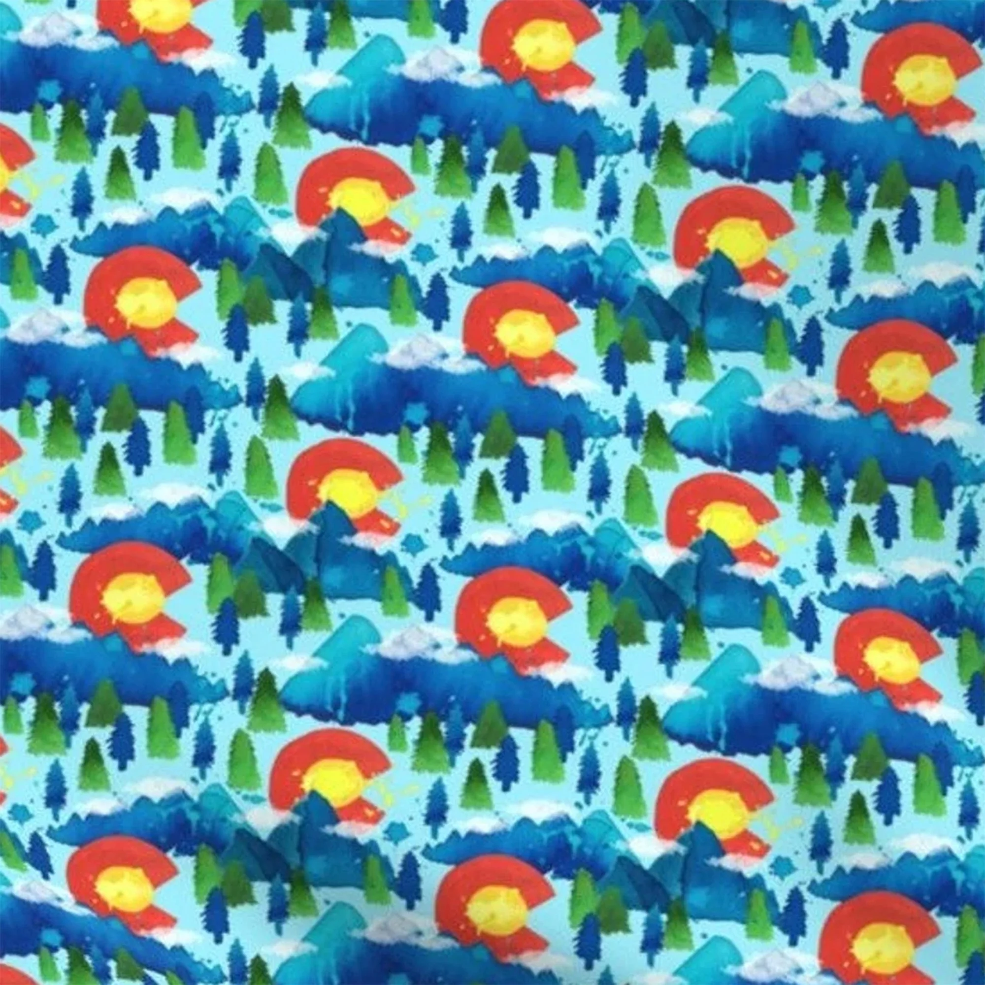 A fabric with blue mountains, green trees and the Colorado flag in a watercolor style.