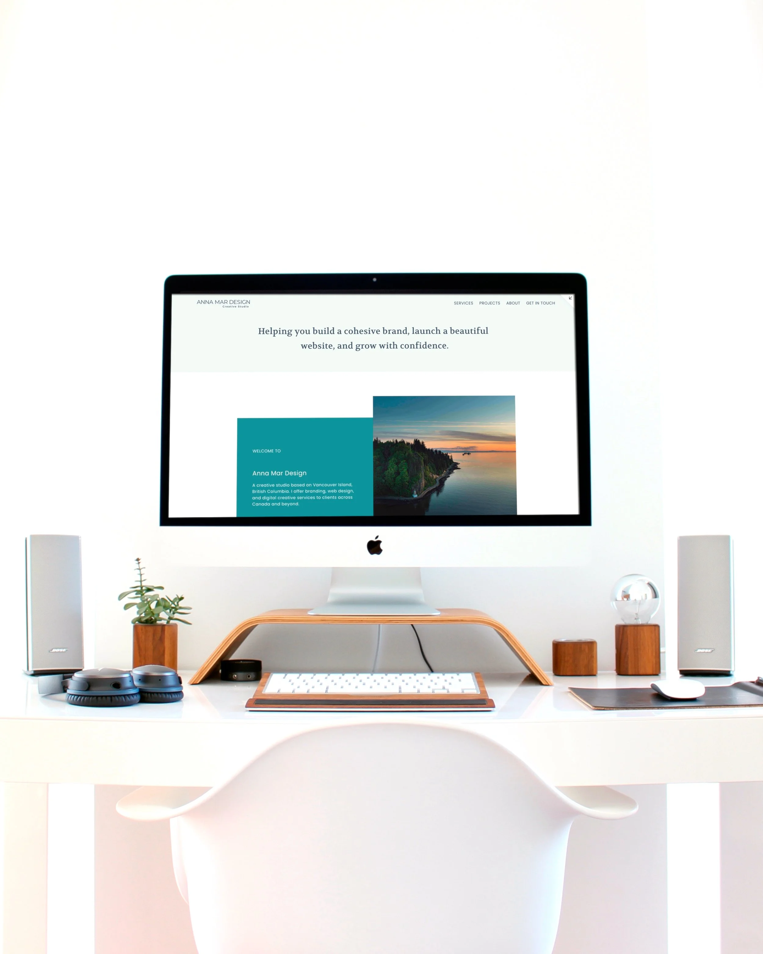 Minimalist computer setup on a desk used for website design work.