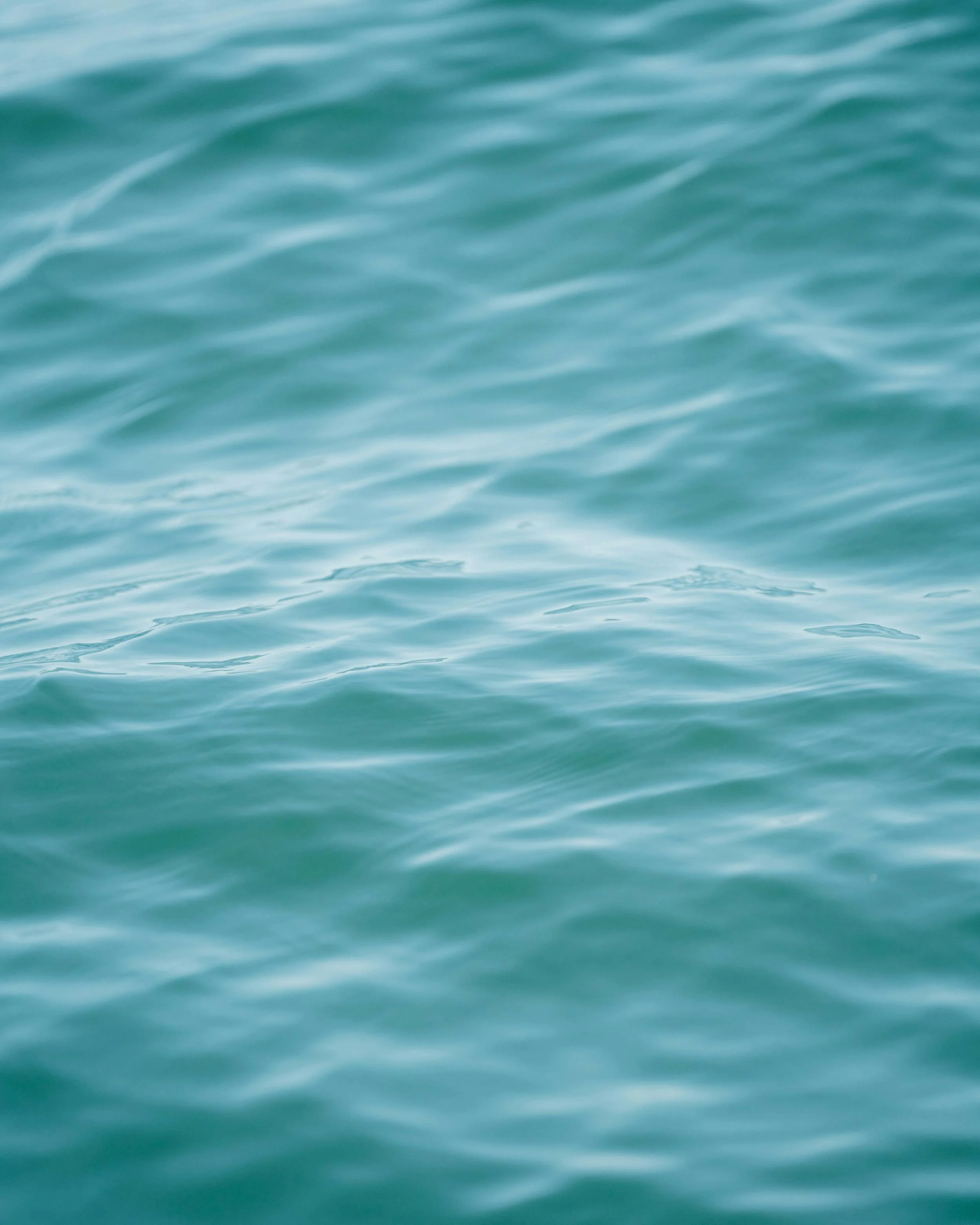 Close-up ocean water texture representing calm, clarity, and creativity.