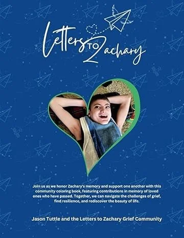 Front cover of a community book honoring Zachary's memory, featuring a child smiling inside a heart-shaped frame with a blue background and paper airplane illustrations, titled 'Letter to Zachary'.