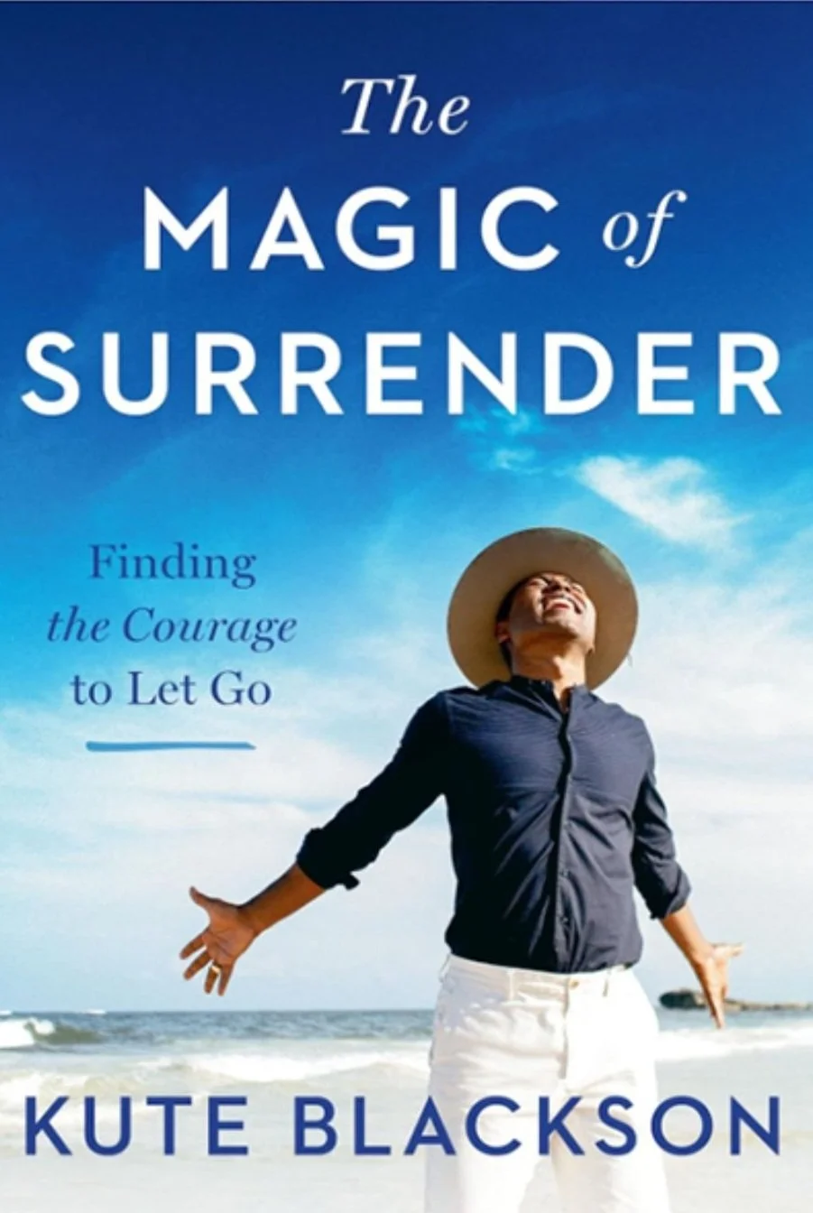 Book cover titled 'The Magic of Surrender' by Kute Blackson, featuring a person standing on the beach with arms outstretched, smiling, under a blue sky.