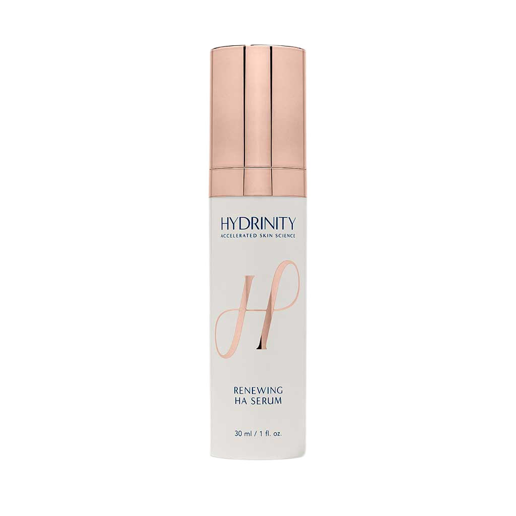 A bottle of Hydrdiny Renewing HA Serum with a white body, pink cap, and label displaying the product name and description.