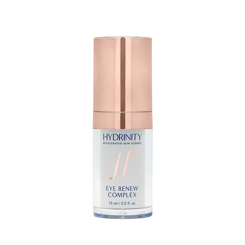 A skincare product called Hydrinity Eye Renew Complex in a white bottle with a rose gold cap.